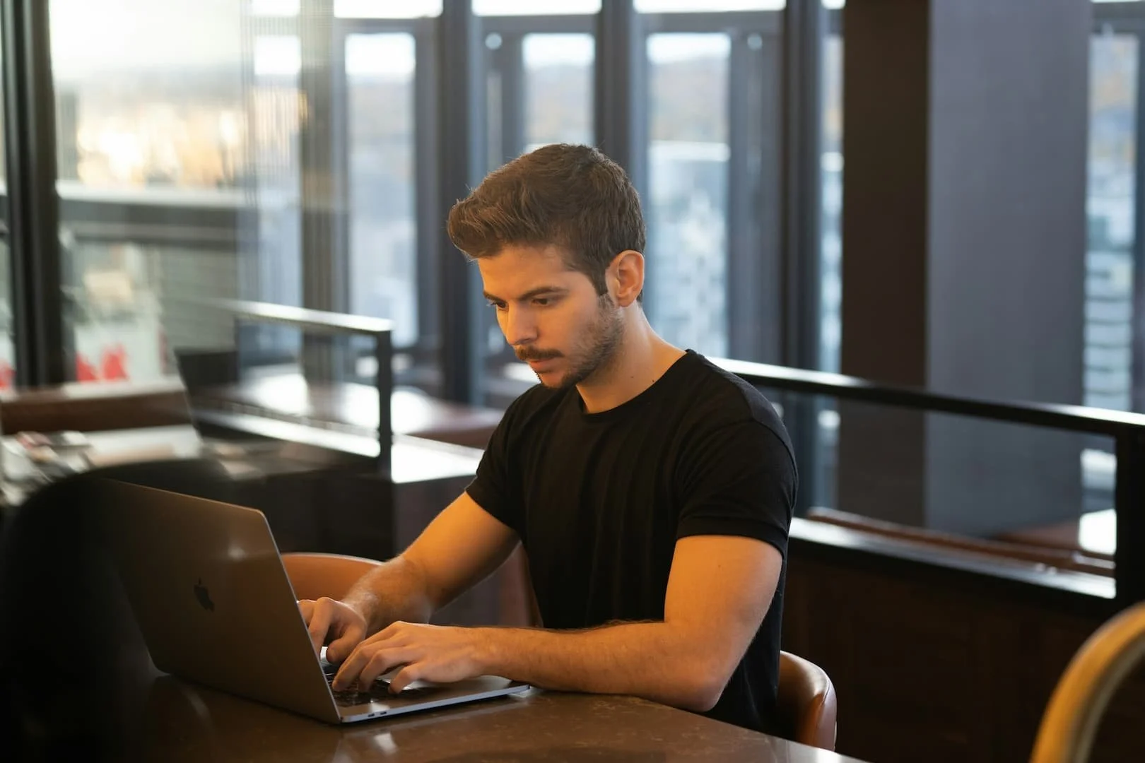 man-in-black-crew-neck-t-shirt-using-macbook