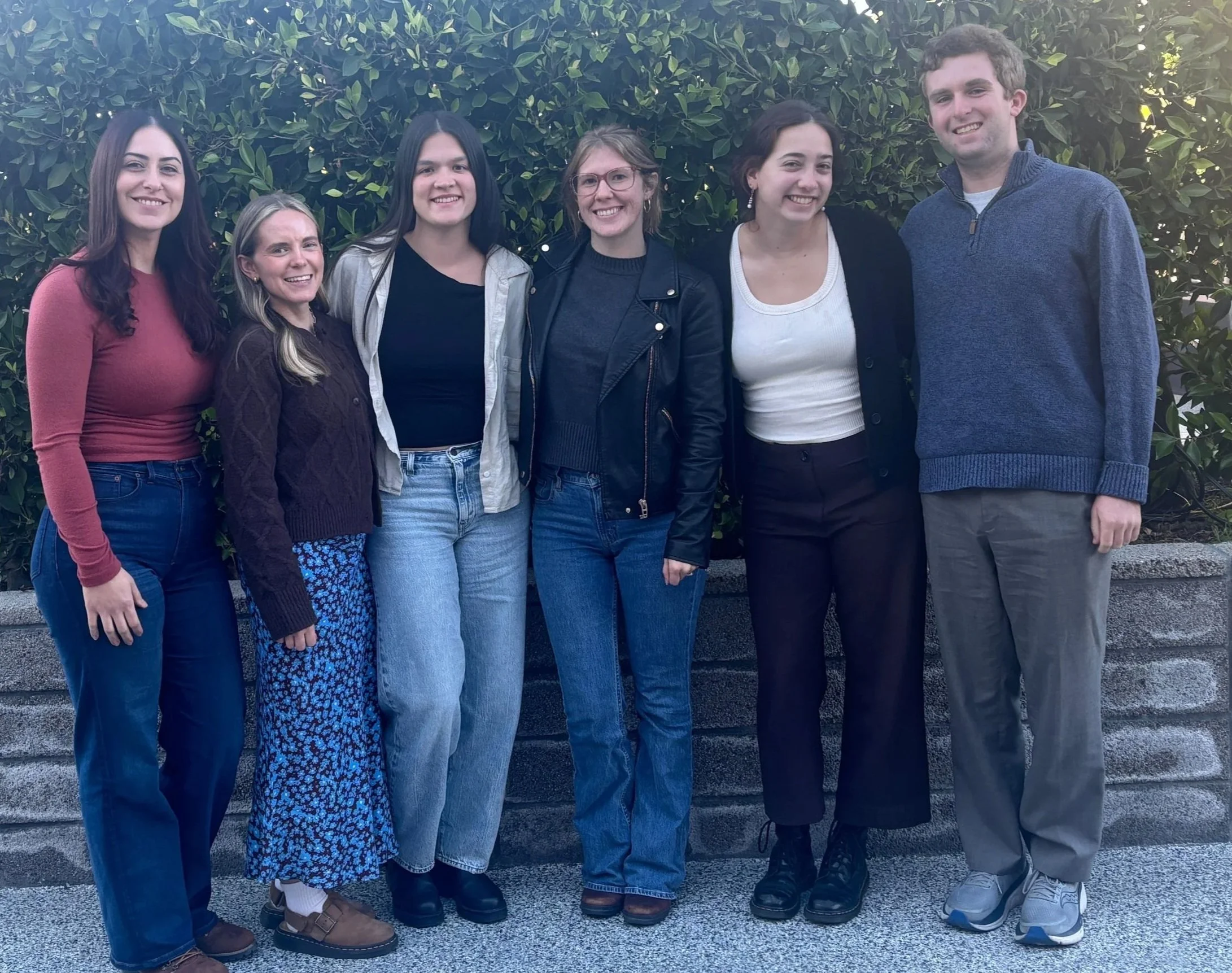 Lab group photo of Maria, Raya, Elisabeth, Ellie, Holland, and Max standing together outdoors