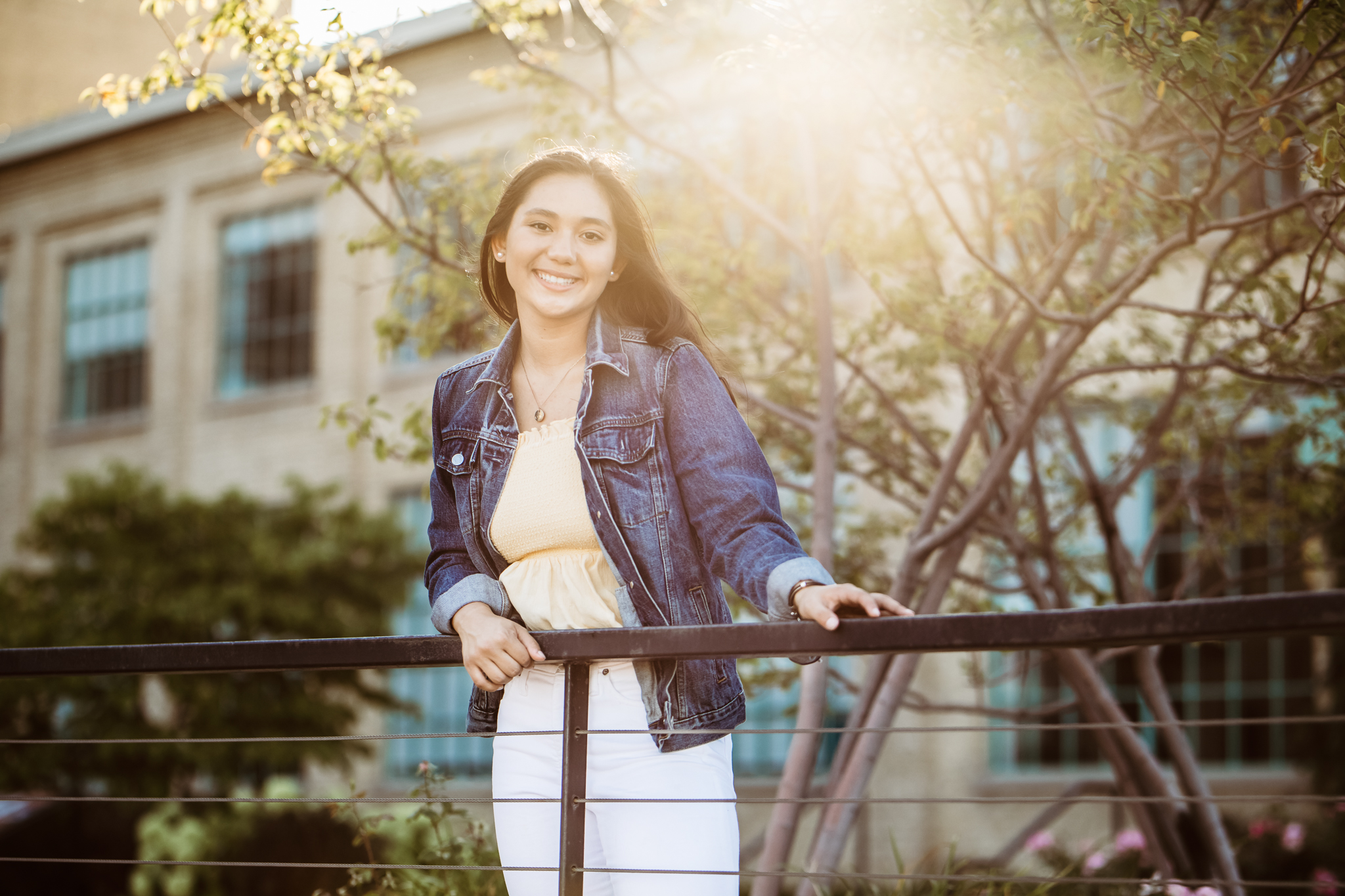 young woman wearing a jean jacket and yellow shirt - Minnesota Senior Photographer