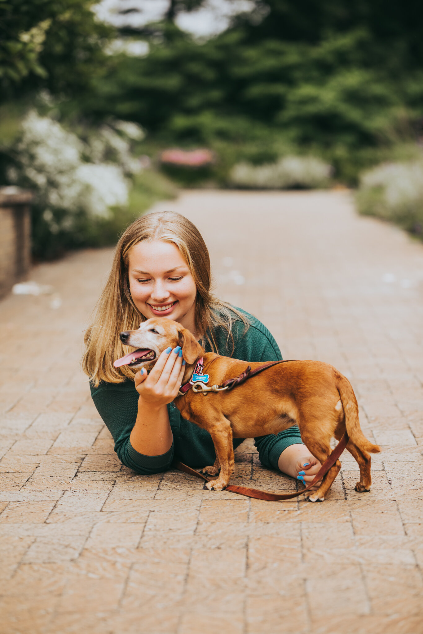 A high school senior with her dog playing in the Noerenberg Memorial Gardens on Lake Minnetonka | Wayzata High School Senior Photographer | AMG Photography