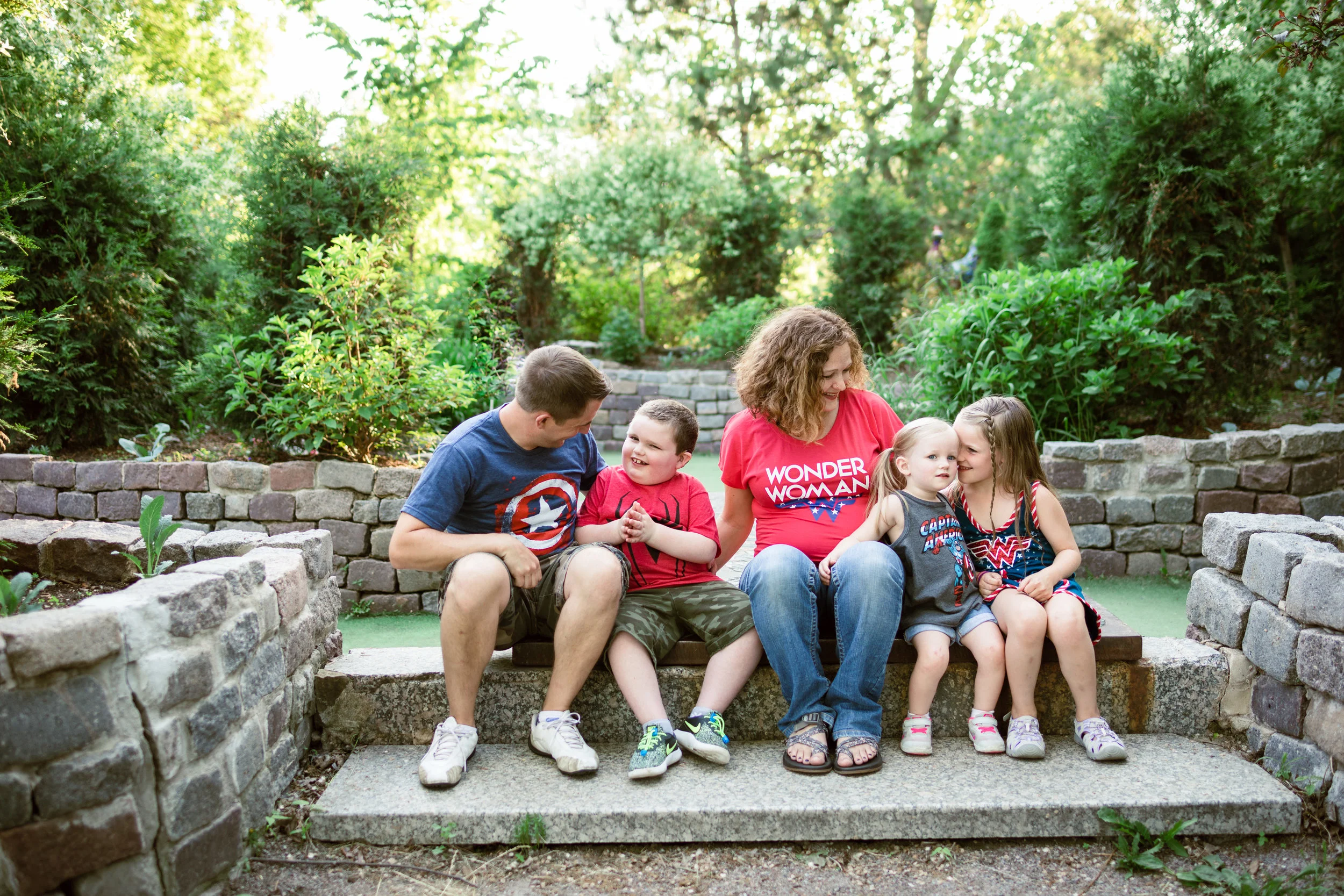 Family in super hero t-shirts sitting and talking - Minnesota Family Photographer