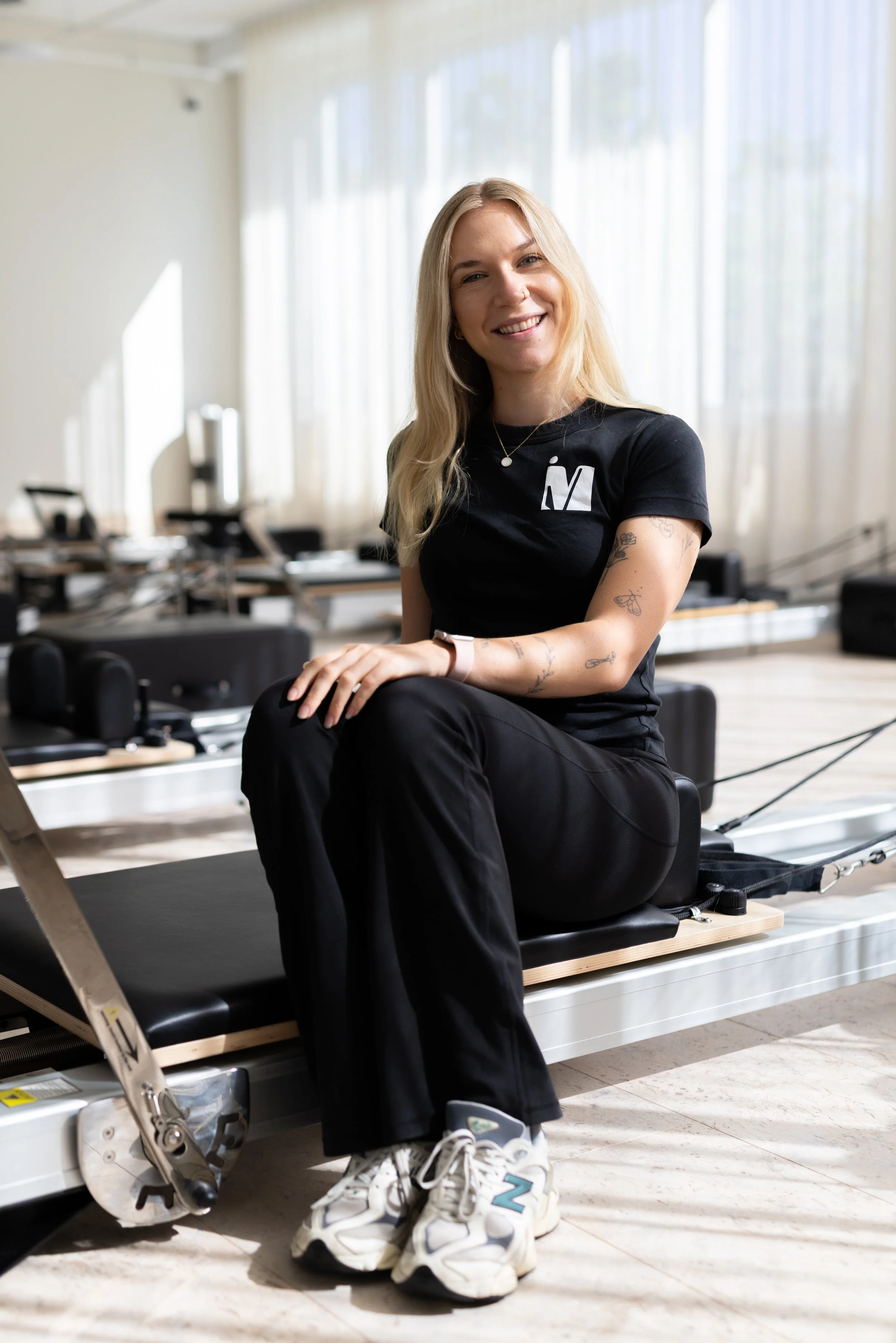 woman sitting relaxed on a pilates machine