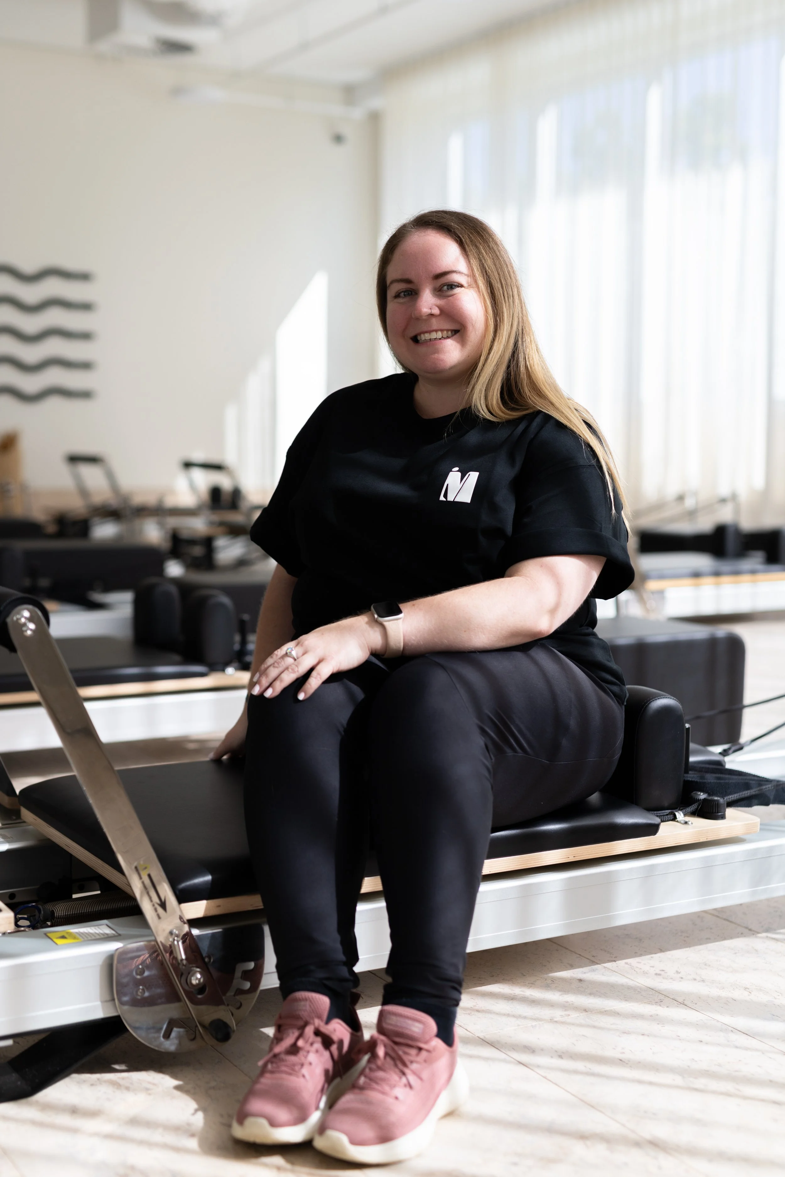 woman sitting on pilates machine