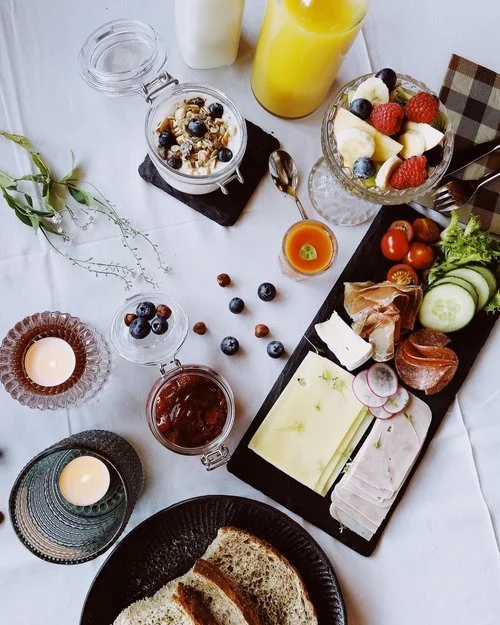 Norwegian breakfast buffet with local cheeses, fresh fruit and homemade jam at Dovrefjell Lodge, Norway