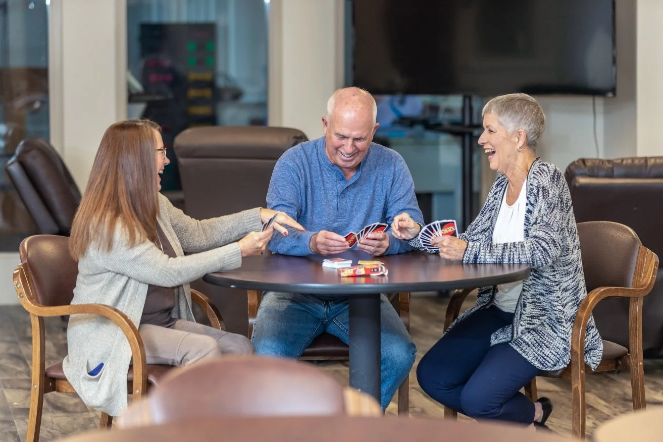 Community members playing Uno.