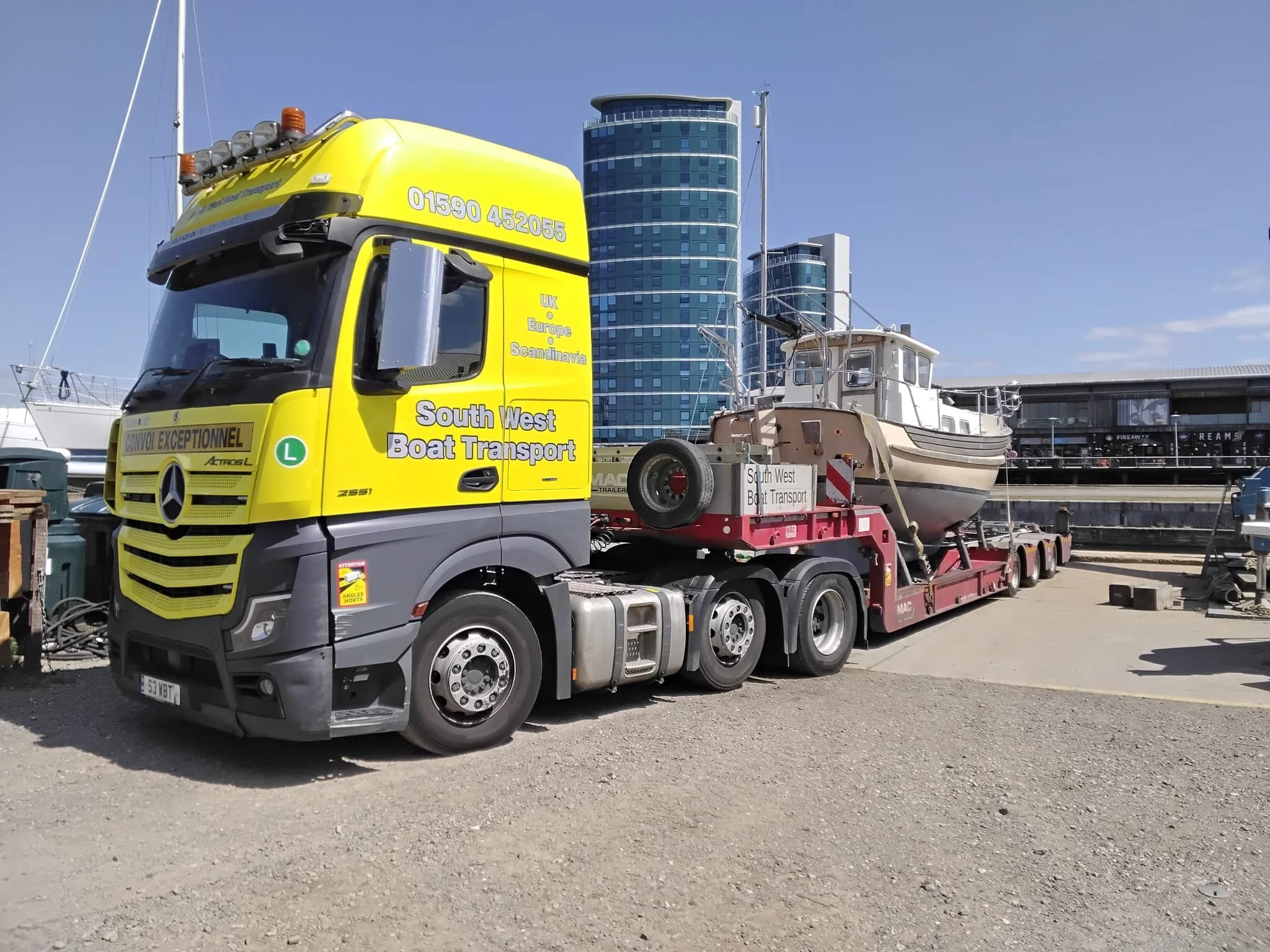 old fashined motor boat on a low loader truck