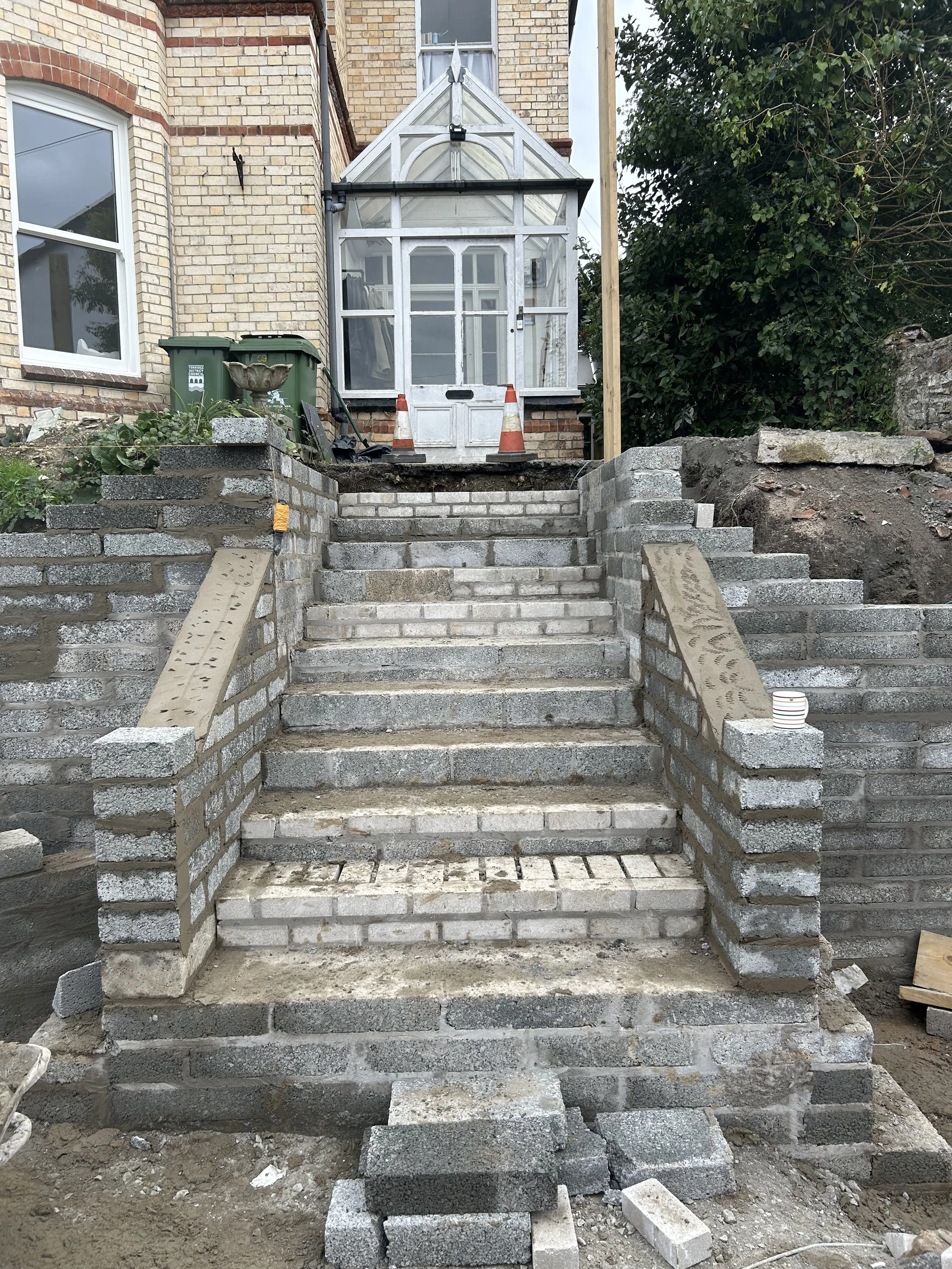 Construction of block steps leading to the main house .