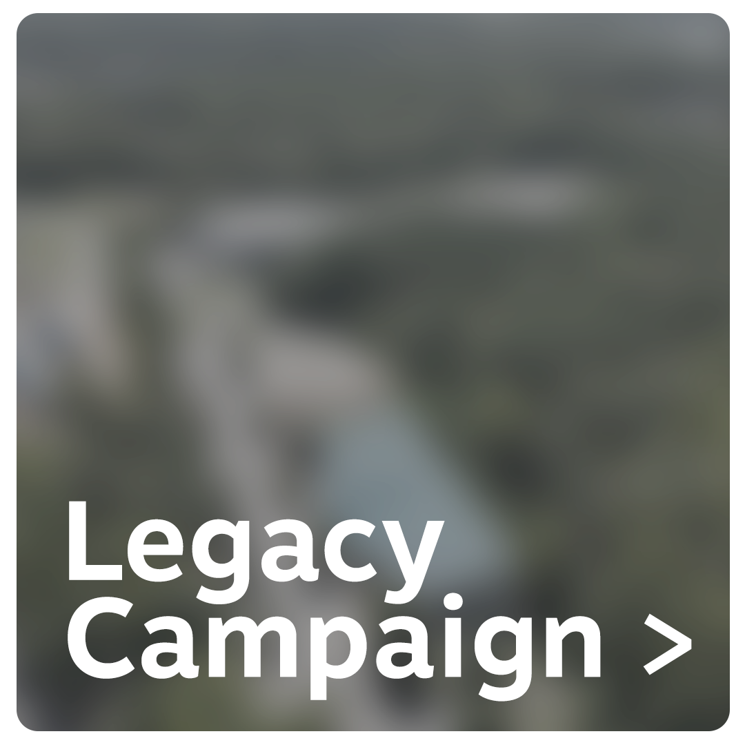 Blurred aerial view of a bridge over a river with text 'Legacy Campaign >' in large white font.