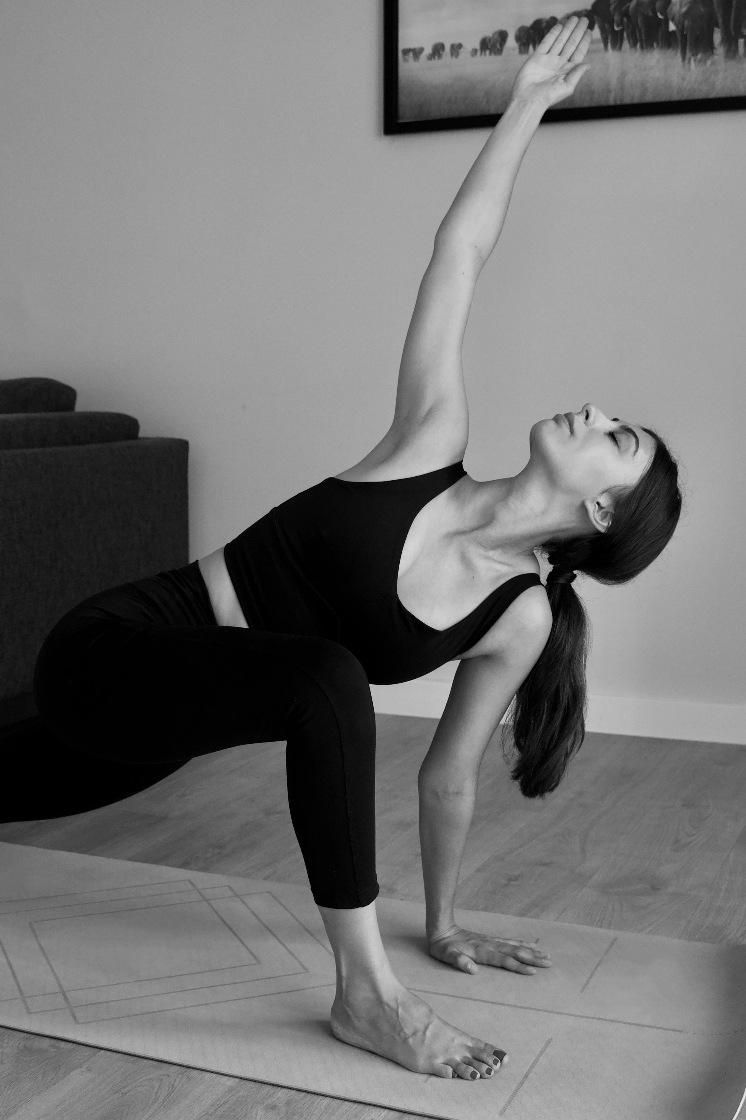 Woman practicing a private yoga backbend at home in Barcelona