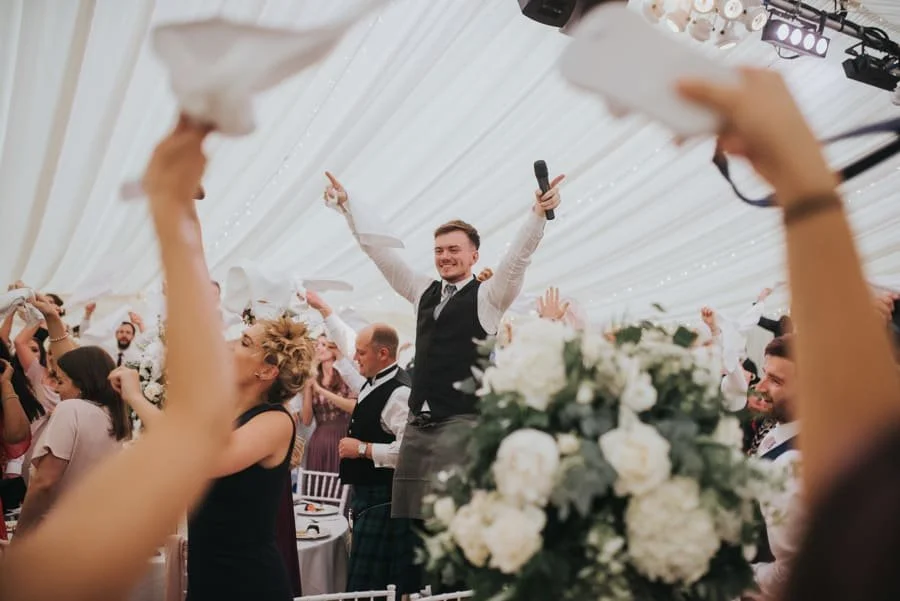 A singer in a marquee at a wedding reception