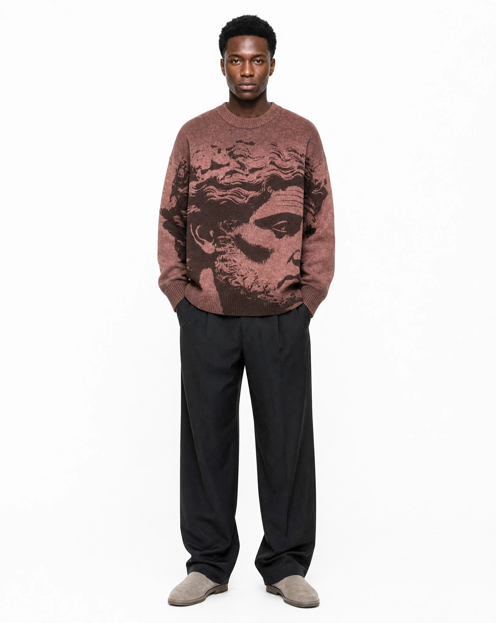 Generated with Kive.ai - Terrence wearing the Greek Intarsia sweater with flowy matte black trousers and grey suede shoes standing in Flat White Studio make sure the studio background is bright flat white with no texture_ tones or other nois.jpg