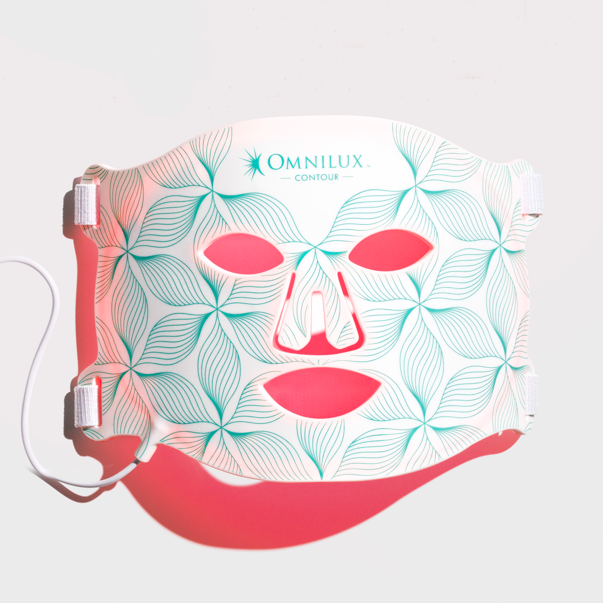 Front view of illuminated Omnilux Contour LED mask used for red light therapy and skin rejuvenation