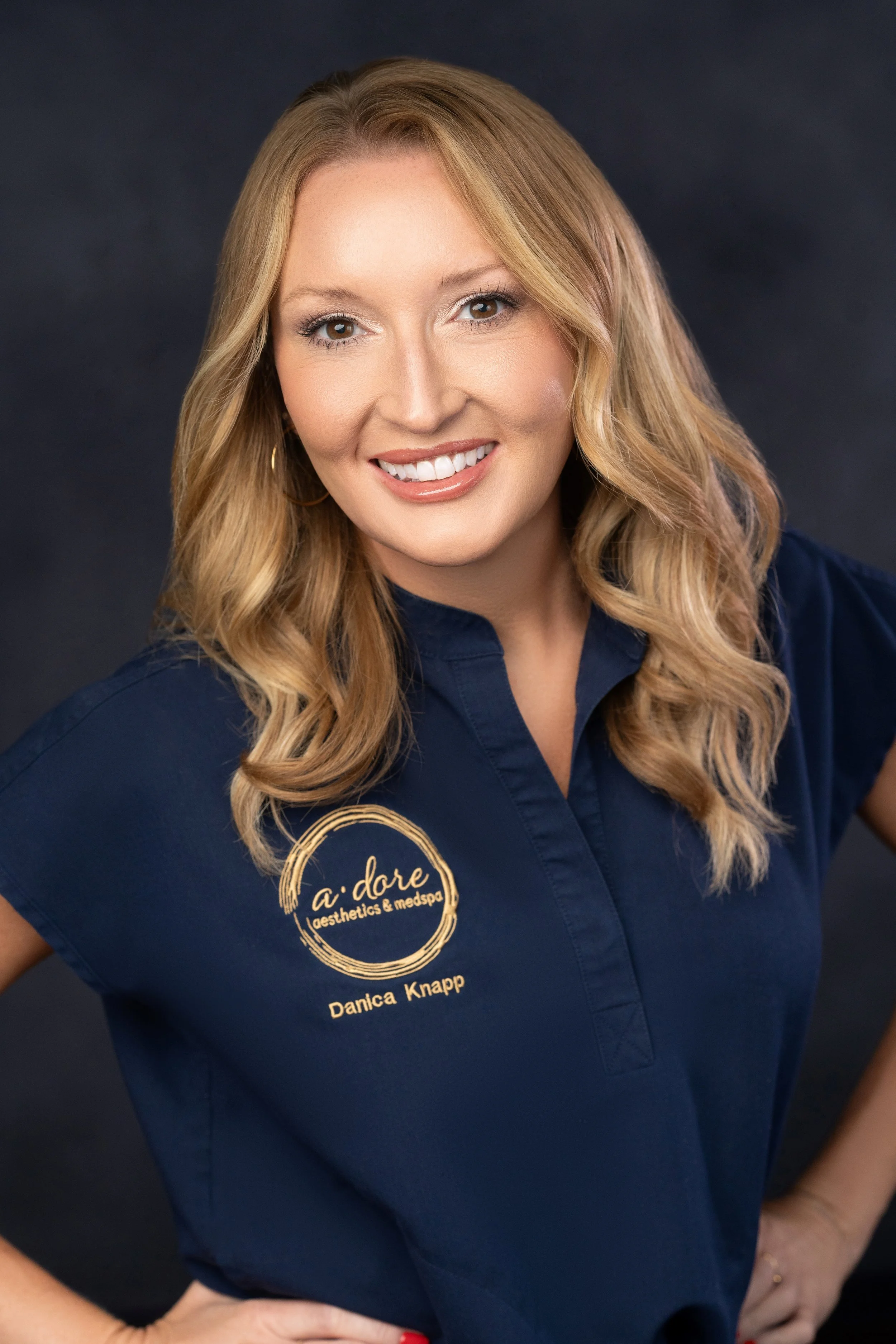 Danica Knapp front desk team member at a.dore aesthetics & medspa assisting patients and scheduling appointments