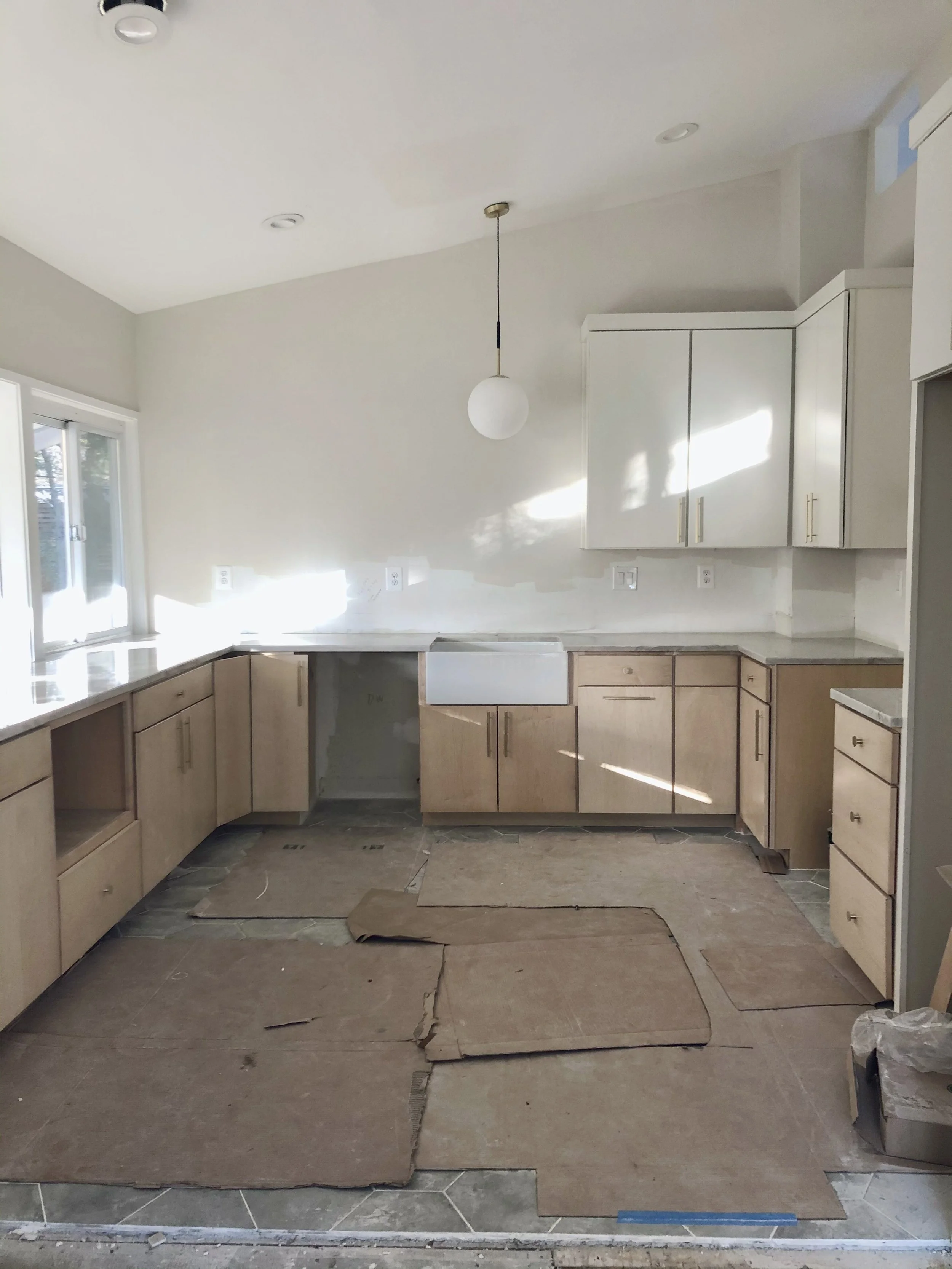 Ceiling raised to follow the roofline, new U-shaped layout framed in, and finishes going in.