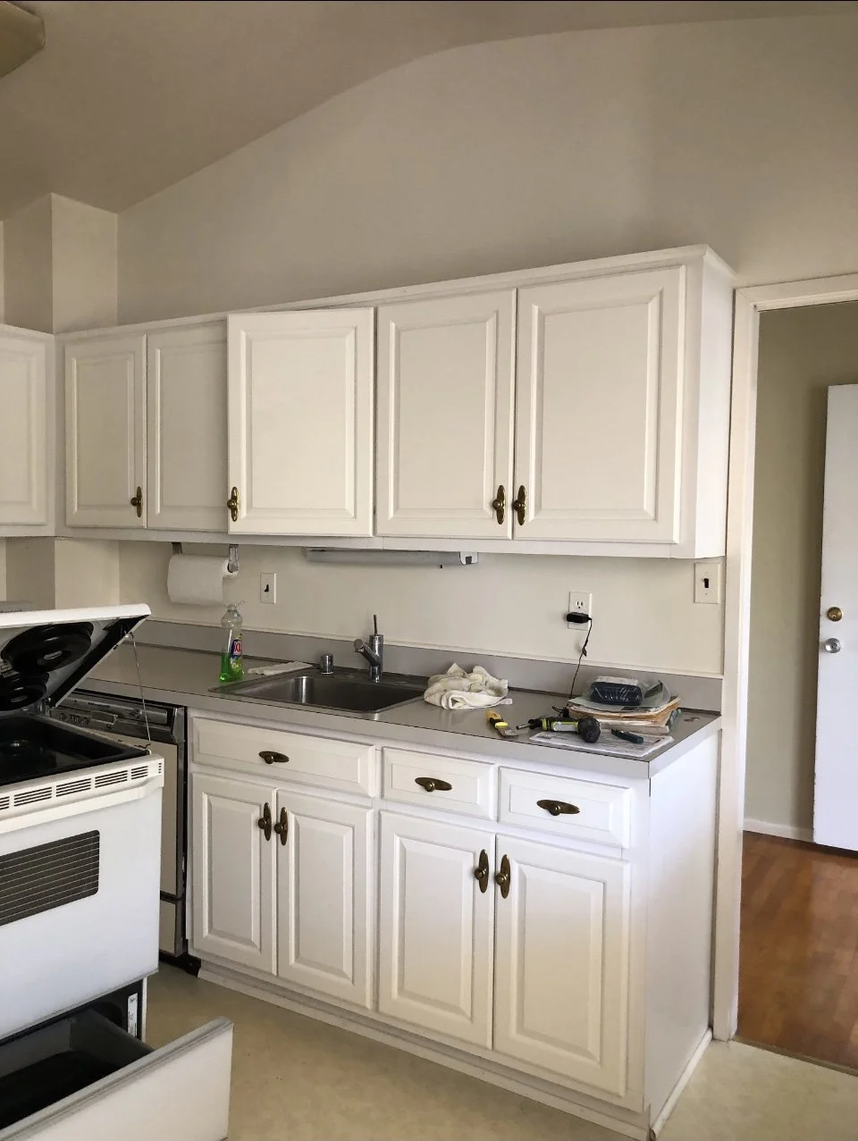 Closed-in and dated U-shaped layout that felt cramped and disconnected from the dining room.