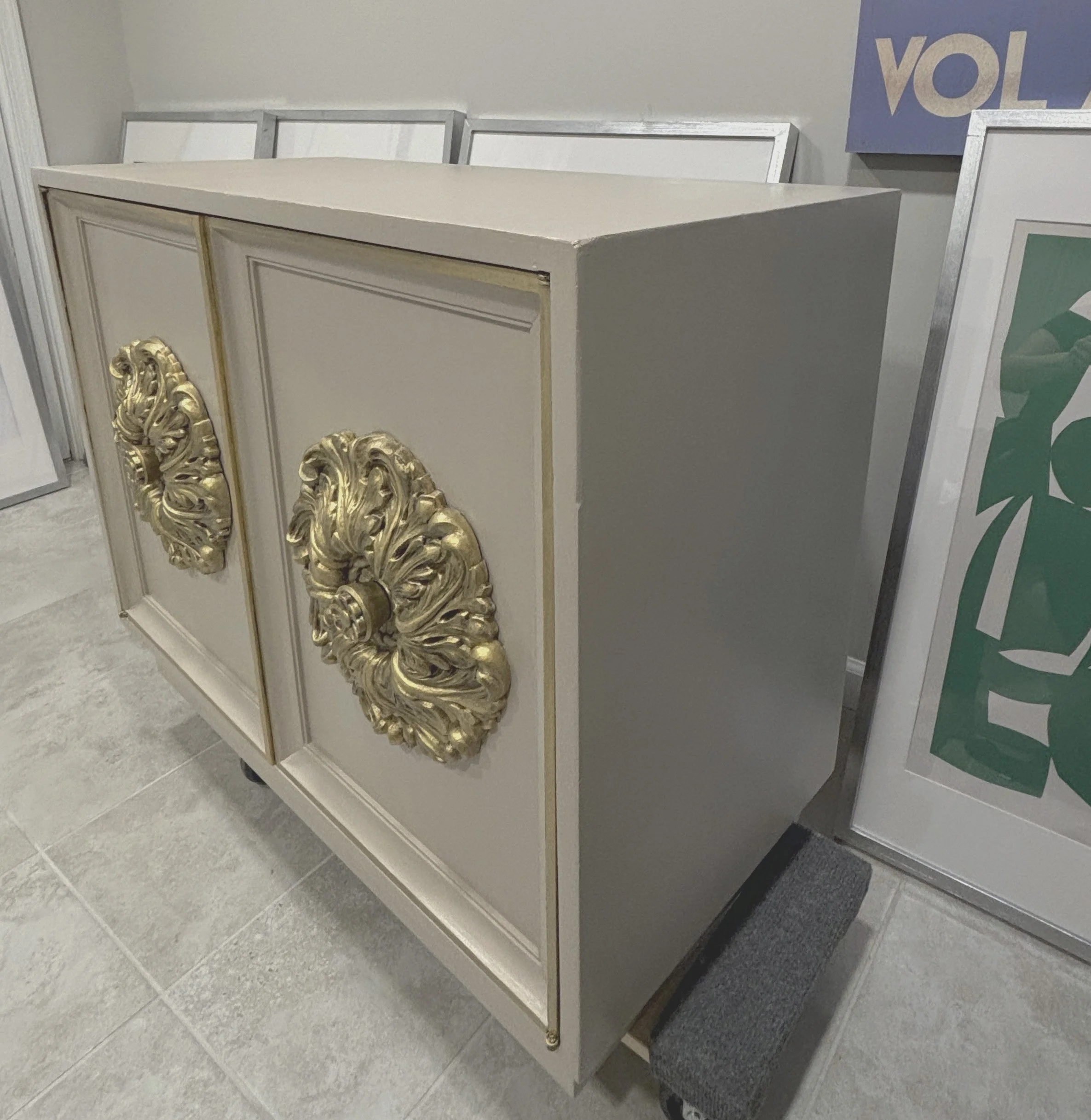 After – angled view
Side view of the updated cabinet, showing the sculptural medallions and crisp new lacquer finish.