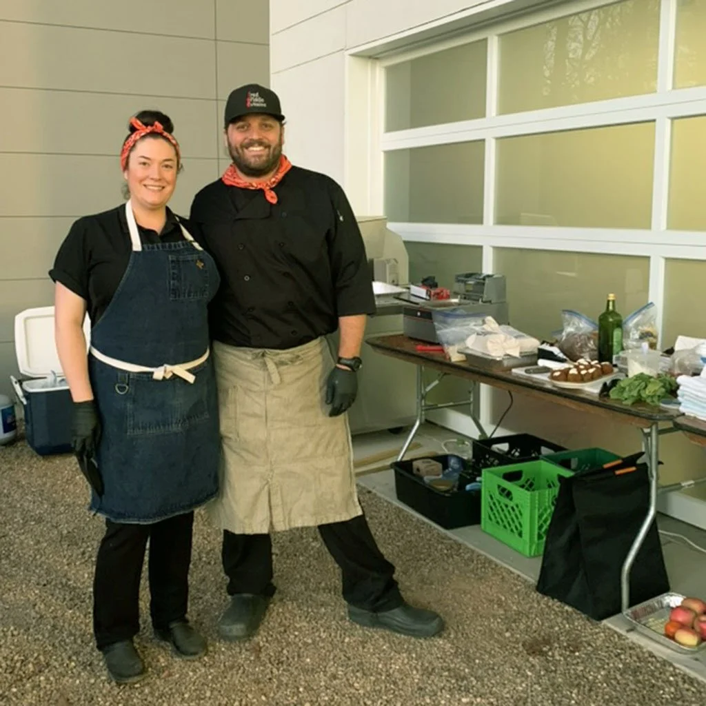 Photo of Eric Beneke and Matt Farr at an outdoor food prep table