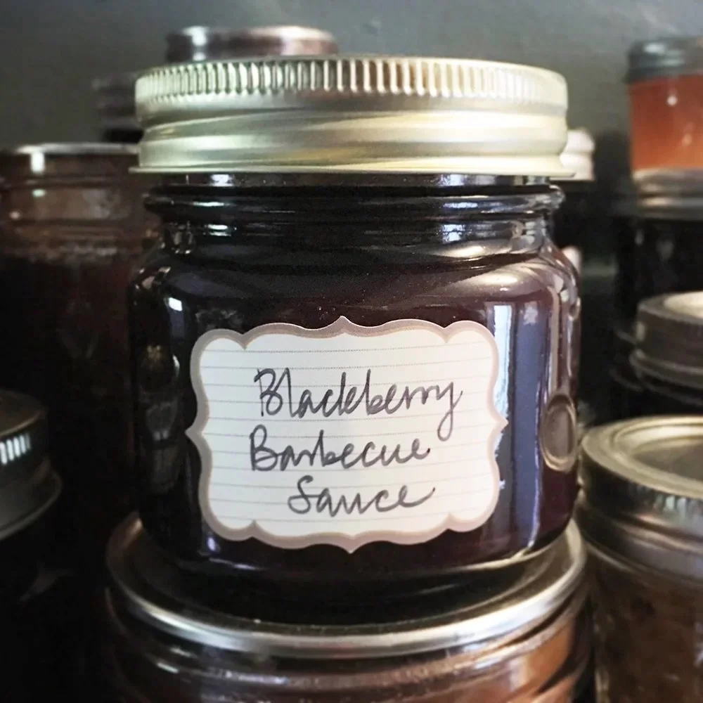 Photograph of a half-pint of home-canned blackberry barbecue sauce.