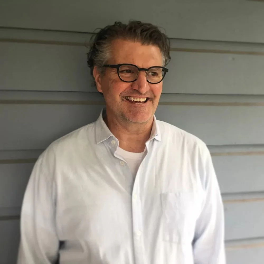 Photograph of chef Cory Schreiber wearing glasses and a white button down shirt.