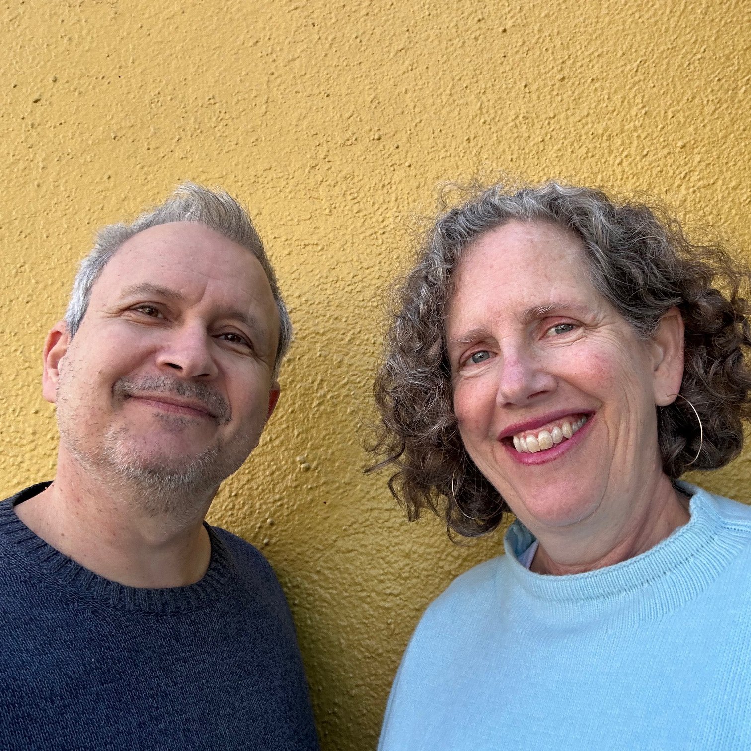 Photograph of Kitchen Table publisher Brett Warnock and Grand Central Bakery Claire Randall against a yellow wall.