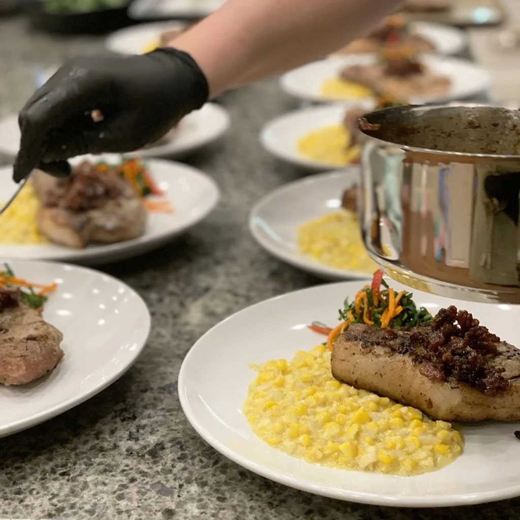 Chef Erica plating food.