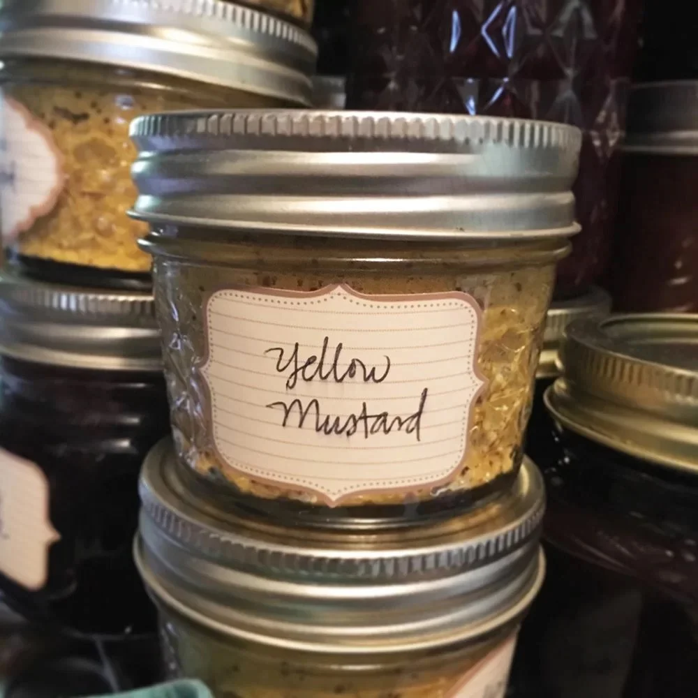 Photograph of a half-pint of home-canned yellow mustard.