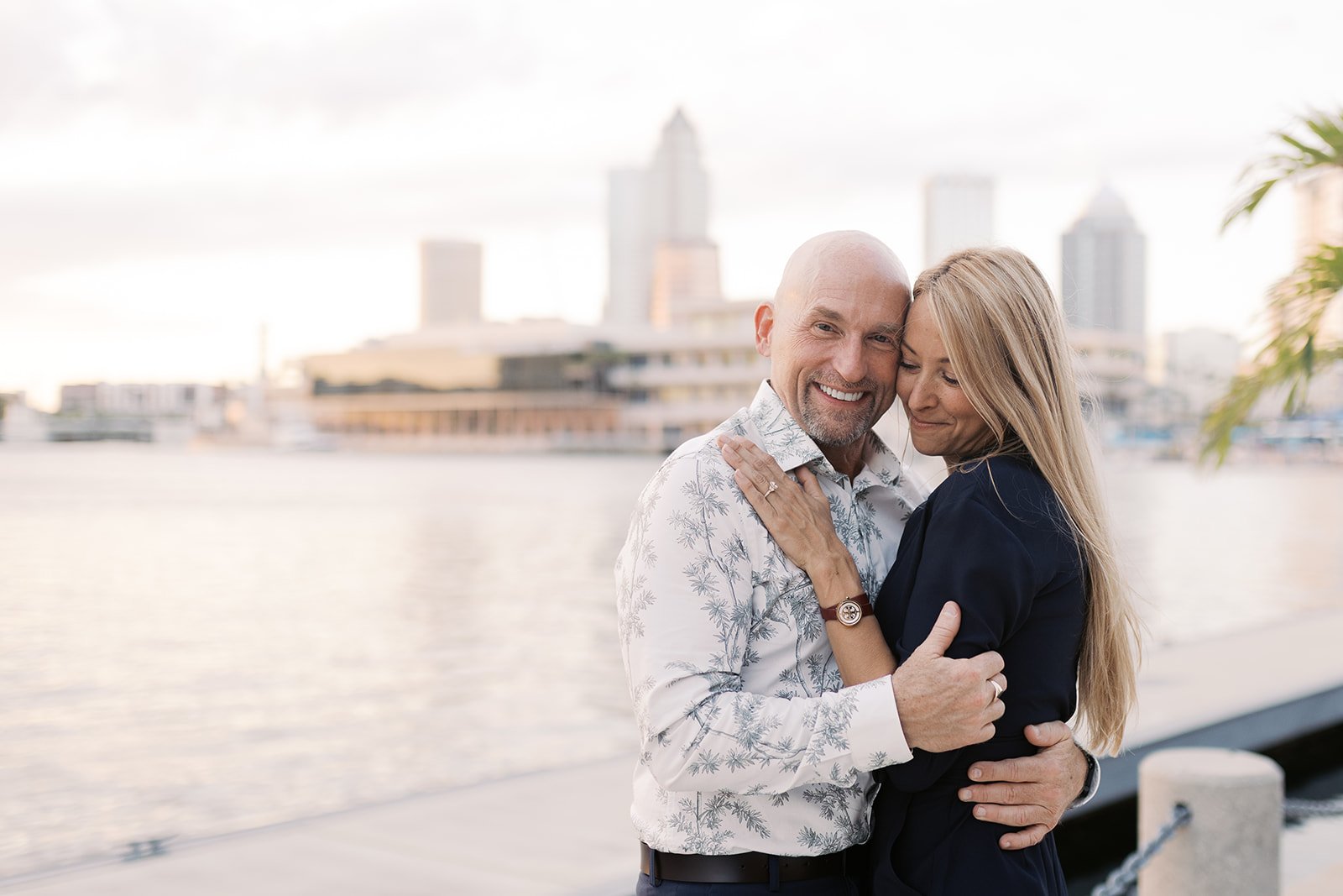 Christian couple in retirement embracing on the Tampa waterfront, representing Christian investing, biblical stewardship, passive income, and faith-based retirement planning.