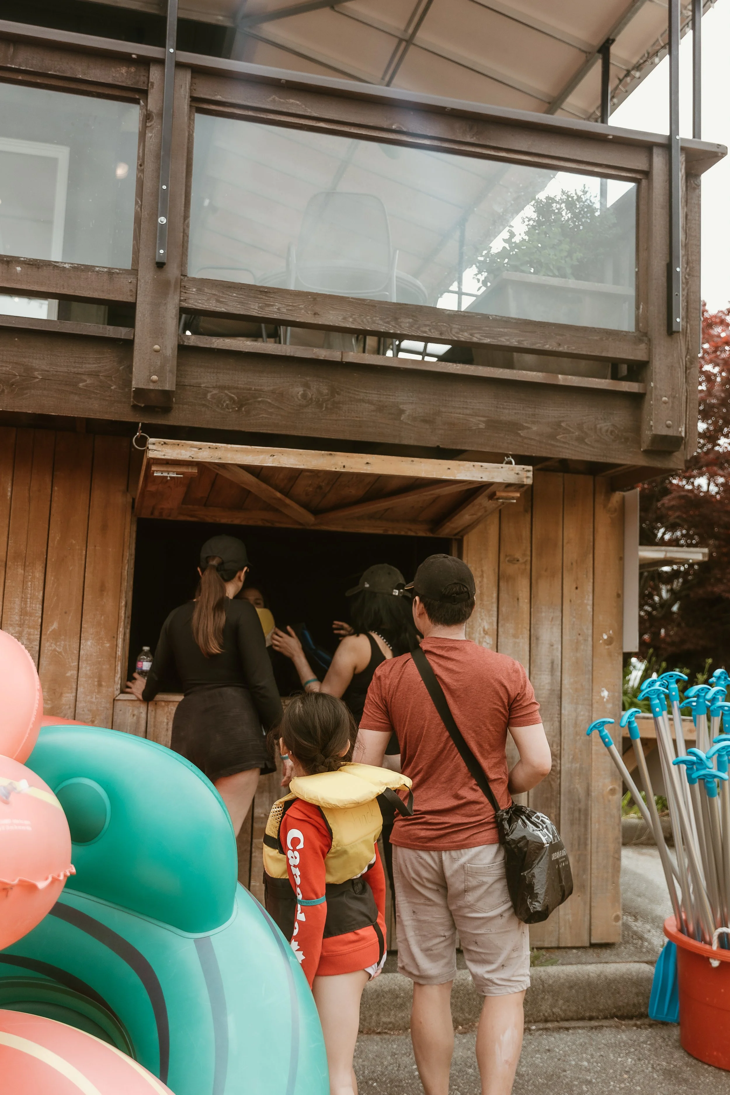 People in line at the Tube Shack counter with colourful tubes nearby.