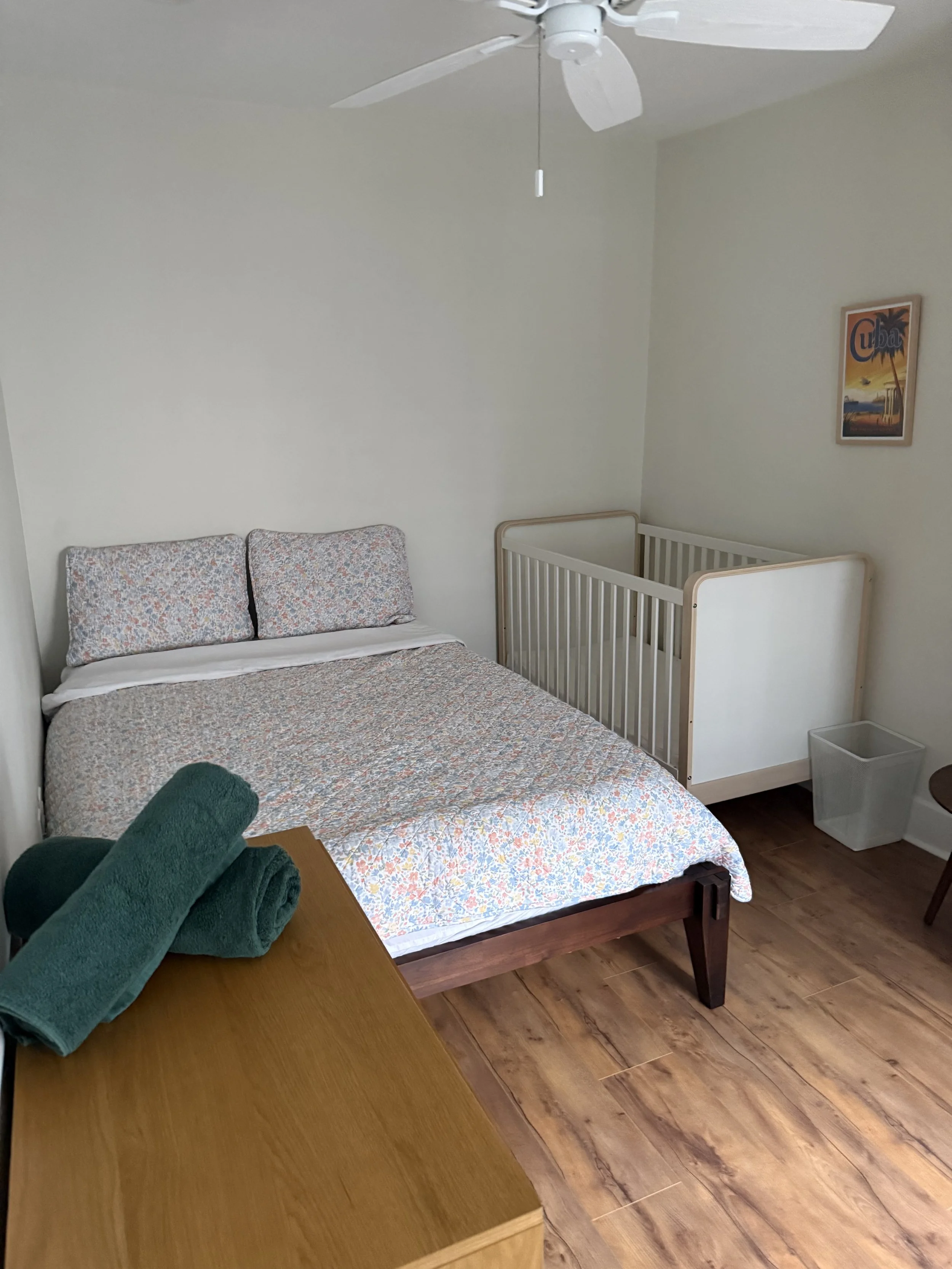 bedroom 2 with queen bed and crib