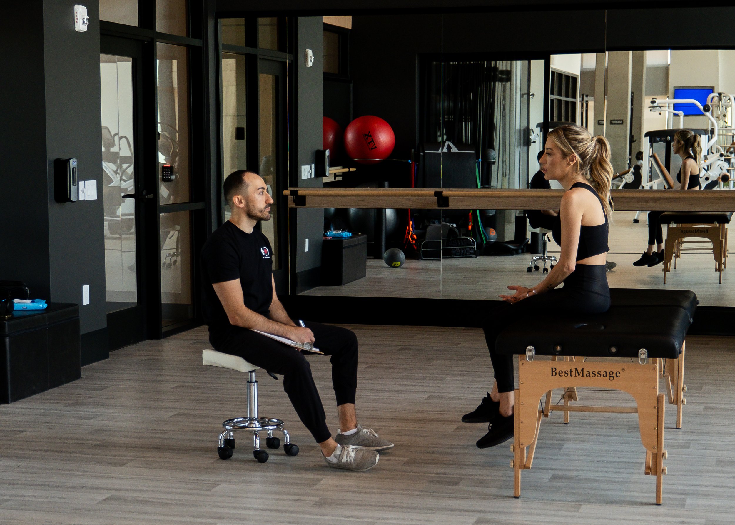 in home physical therapist talking to client about joint pain and mobility.