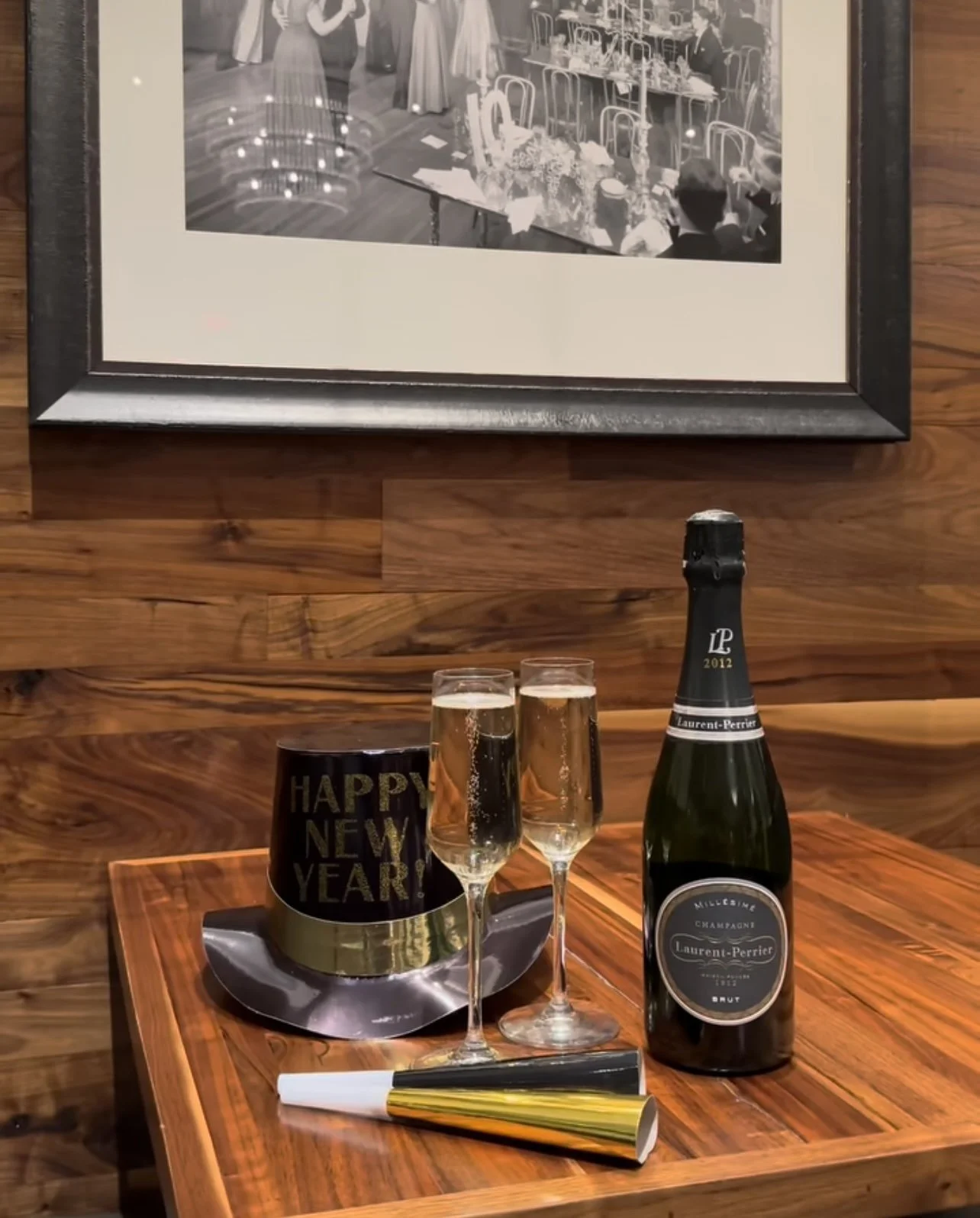 Champagne chilling beneath framed artwork in a private dining room at Brendon's Catch 23