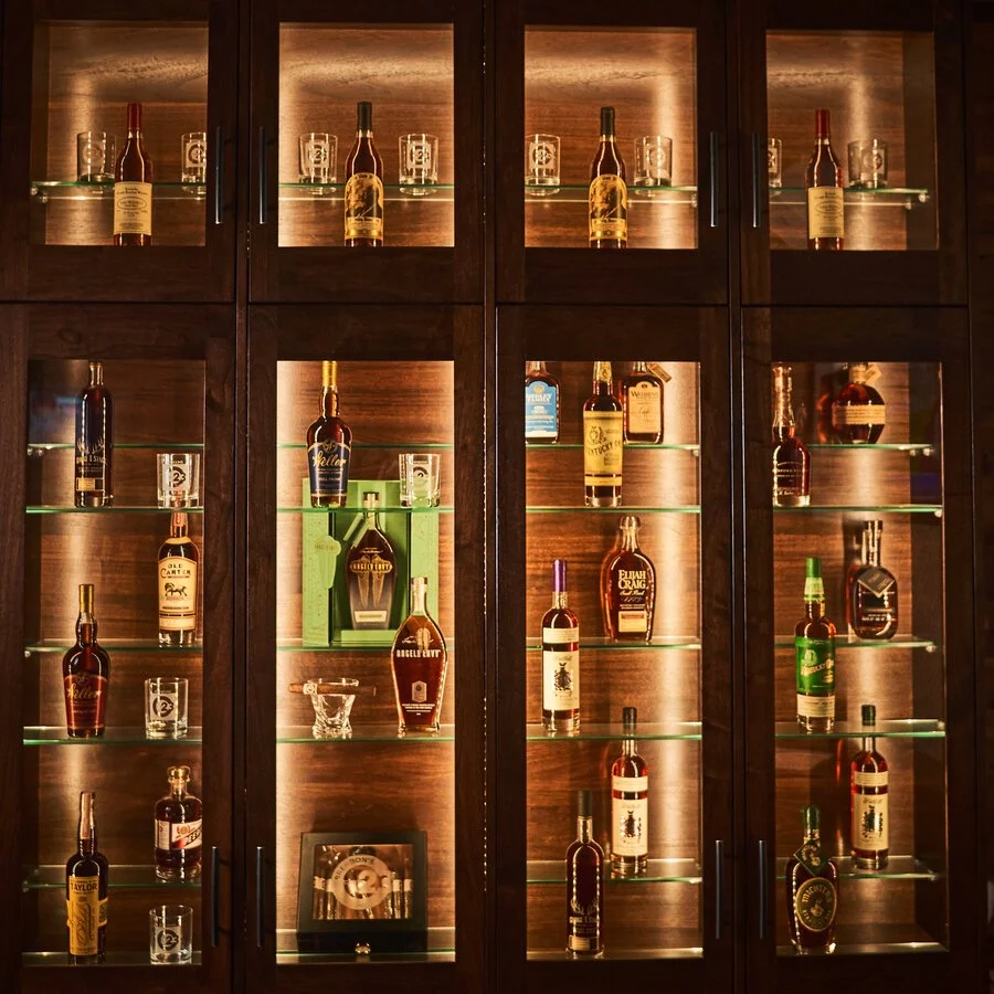 Backlit cabinets holding part of the 100-plus Kentucky bourbon selection at Brendon's Catch 23