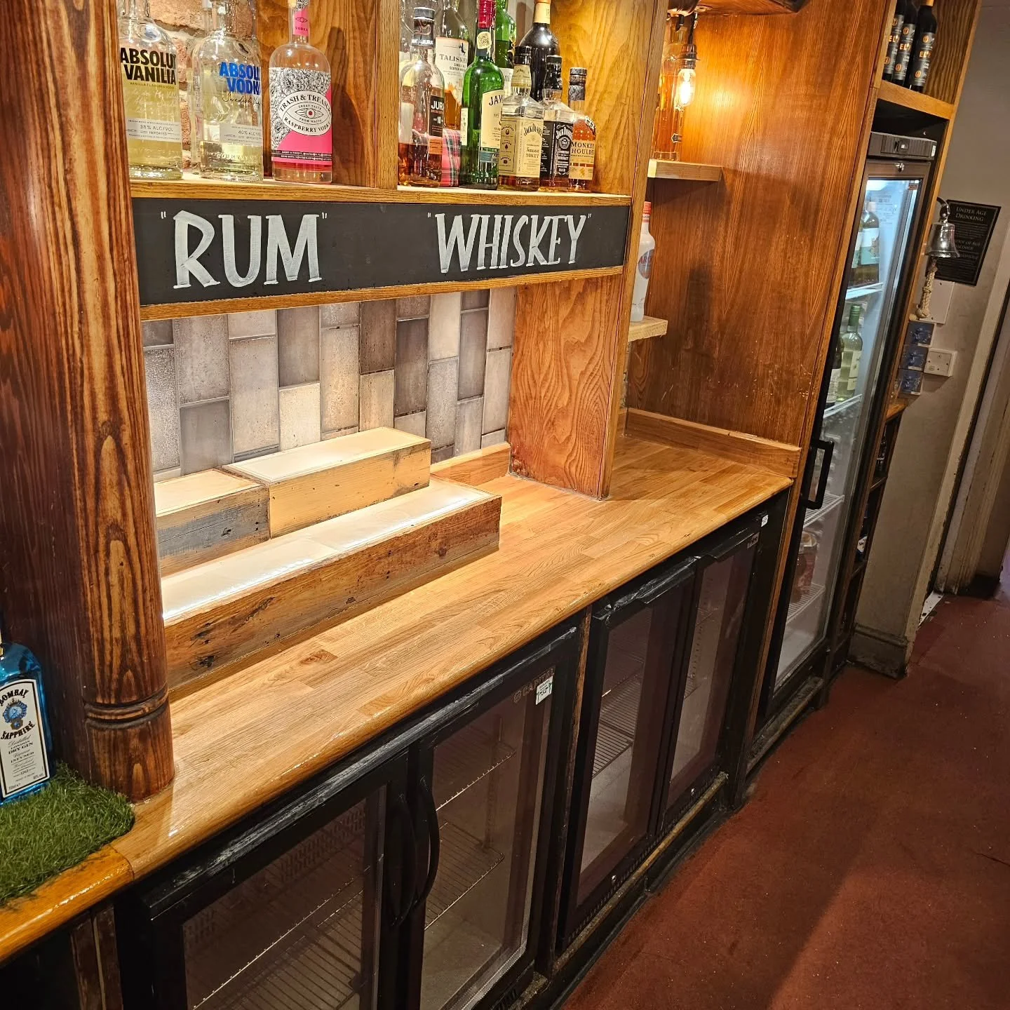 Swipe for the before!

A recent project took the team to Winchester to replace a solid wooden work top behind the bar, which had seen better days! 

The worktop was profiled onsite to match the rest of the bar area, and our team carried out the work 