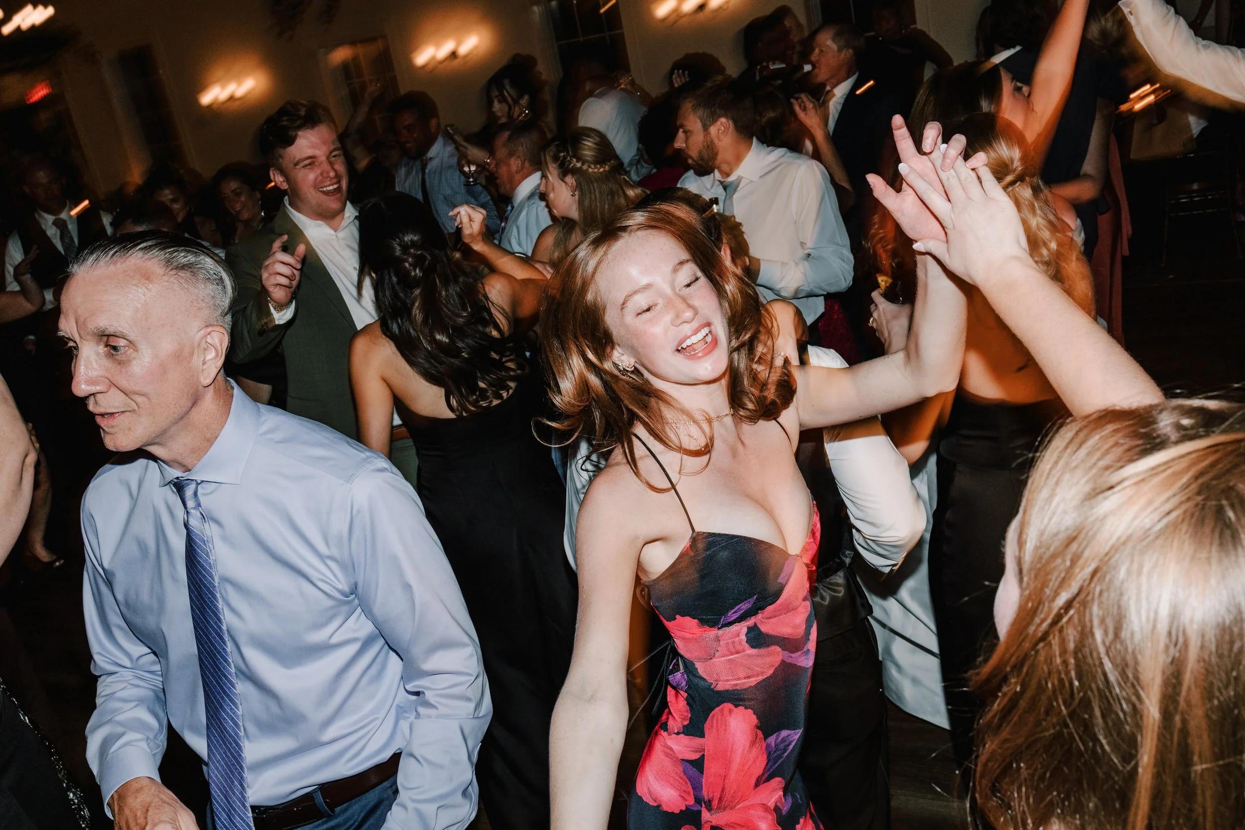 People dancing and celebrating at a lively indoor party or event.