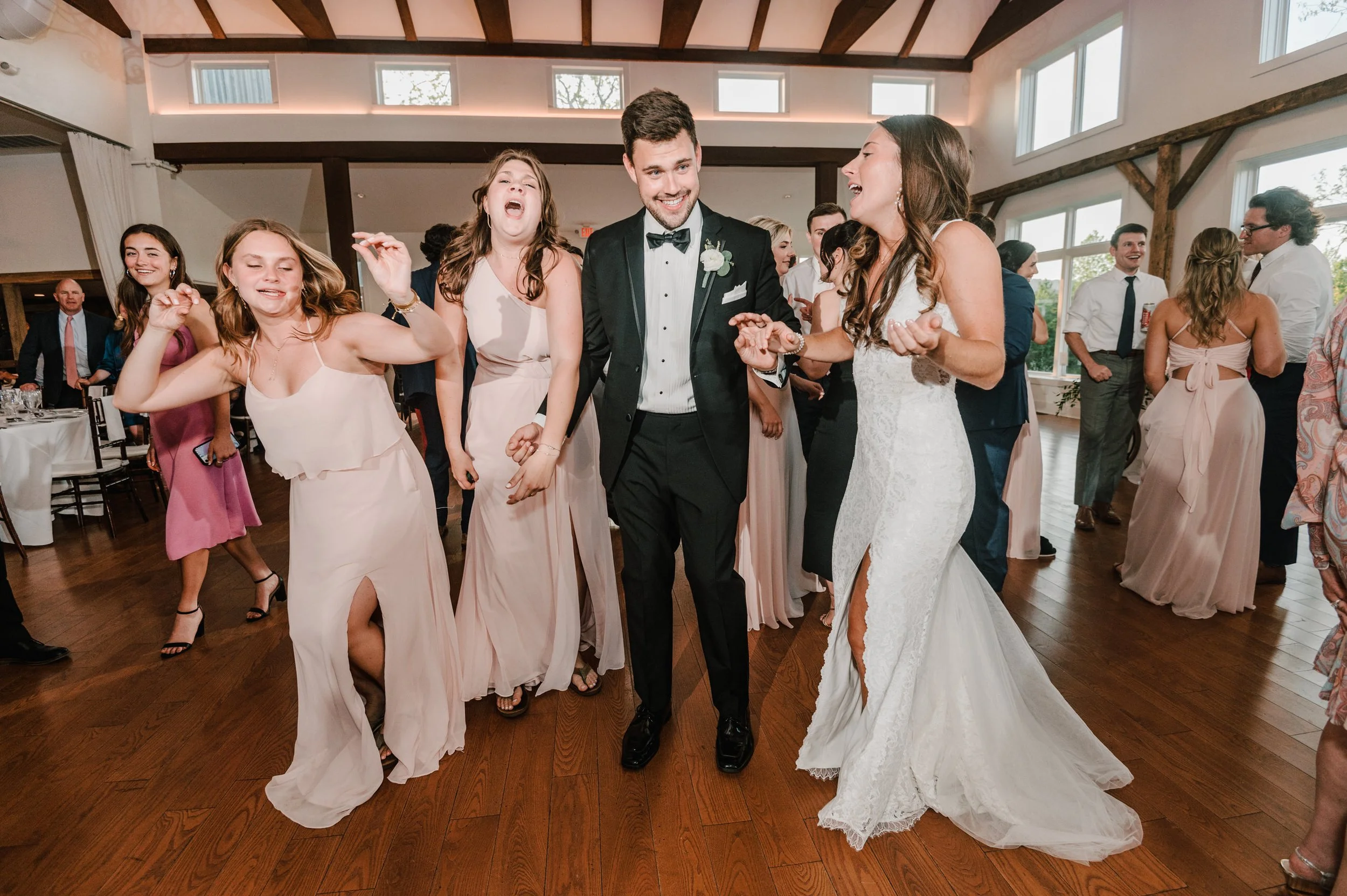 Wedding reception with people dancing and enjoying themselves.