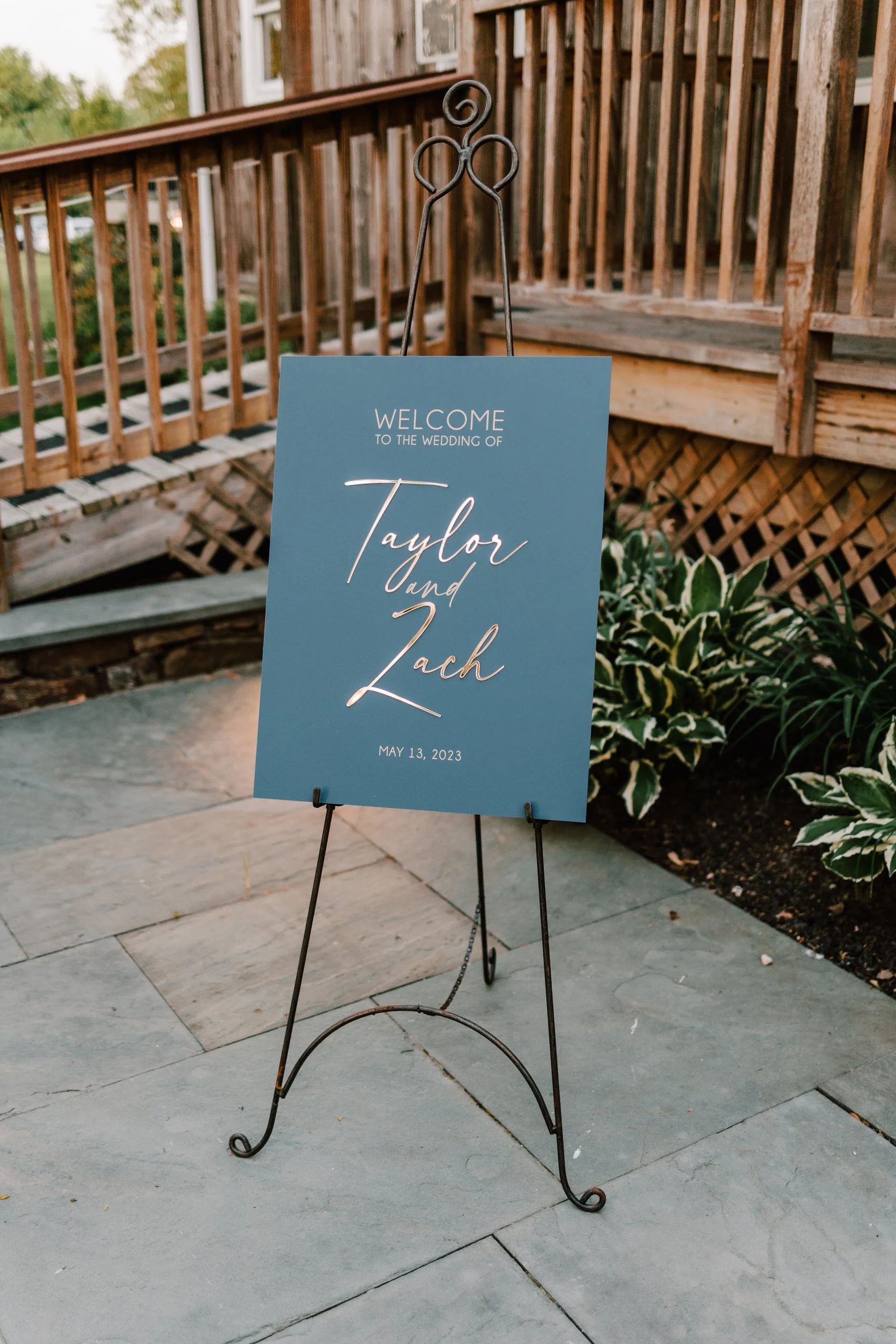 Wedding welcome sign on an easel with the names Taylor and Zach and the date May 13, 2023