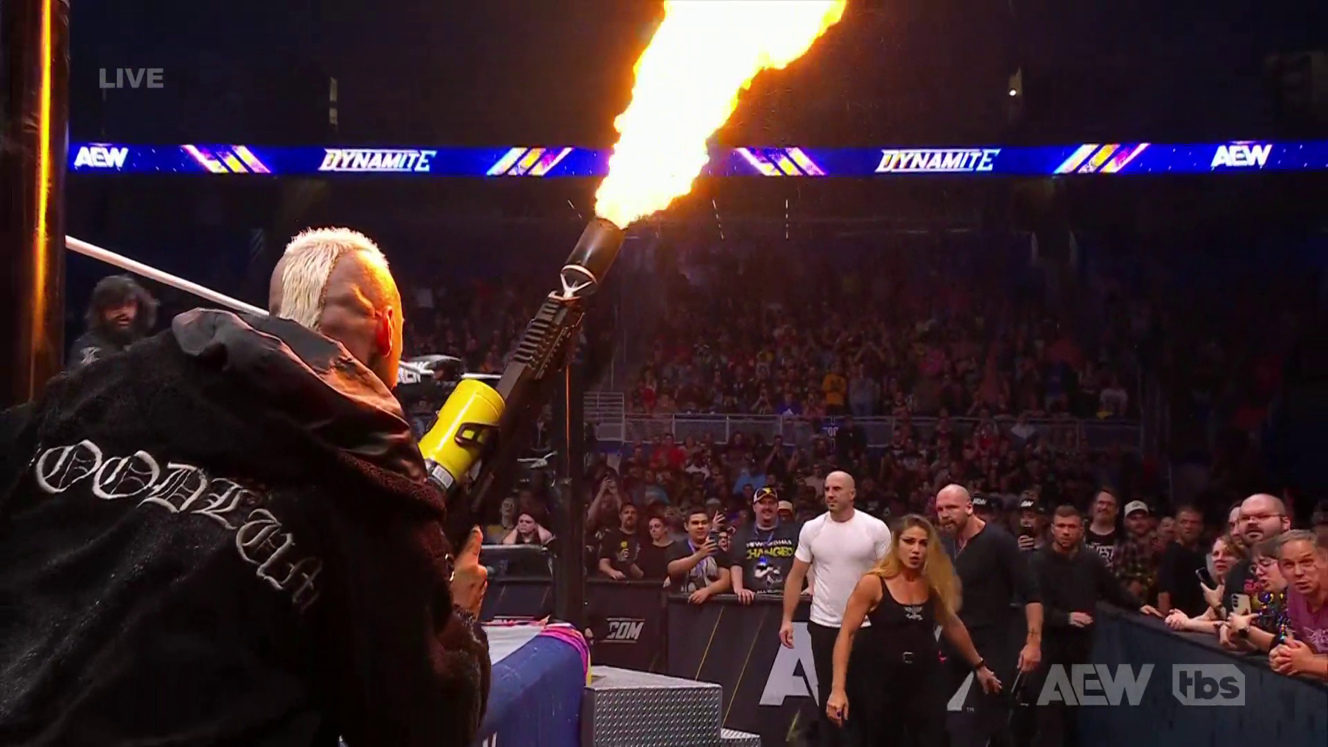 Darby Allin using a Super Scorcher flamethrower during an AEW Dynamite segment.