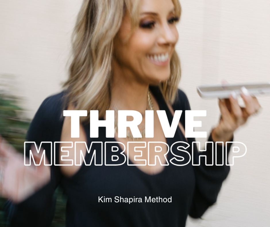 Women smiling and looking at her phone.