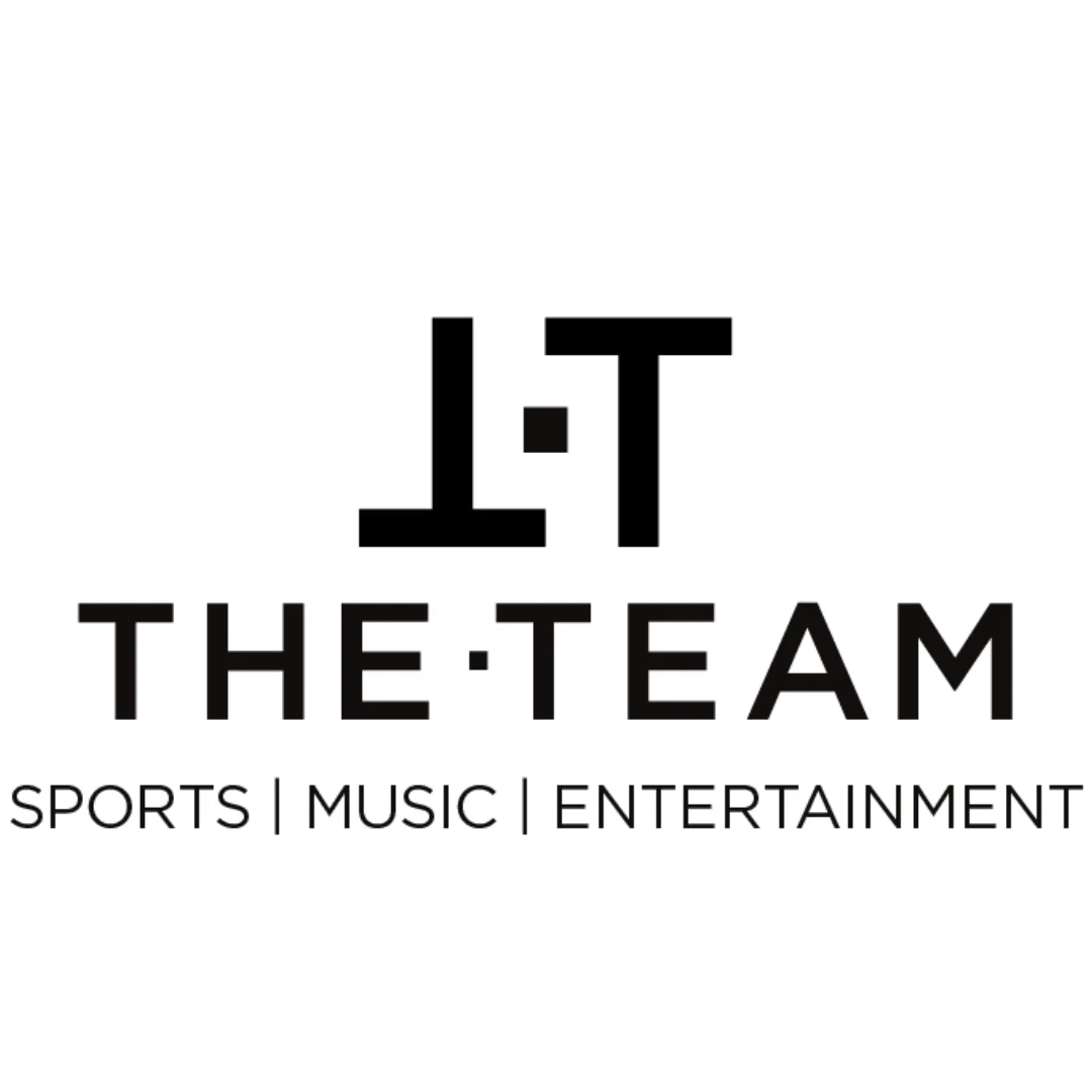 Logo with a large stylized 'J T' above the words 'THE TEAM' and the tagline 'SPORTS | MUSIC | ENTERTAINMENT' in black text.