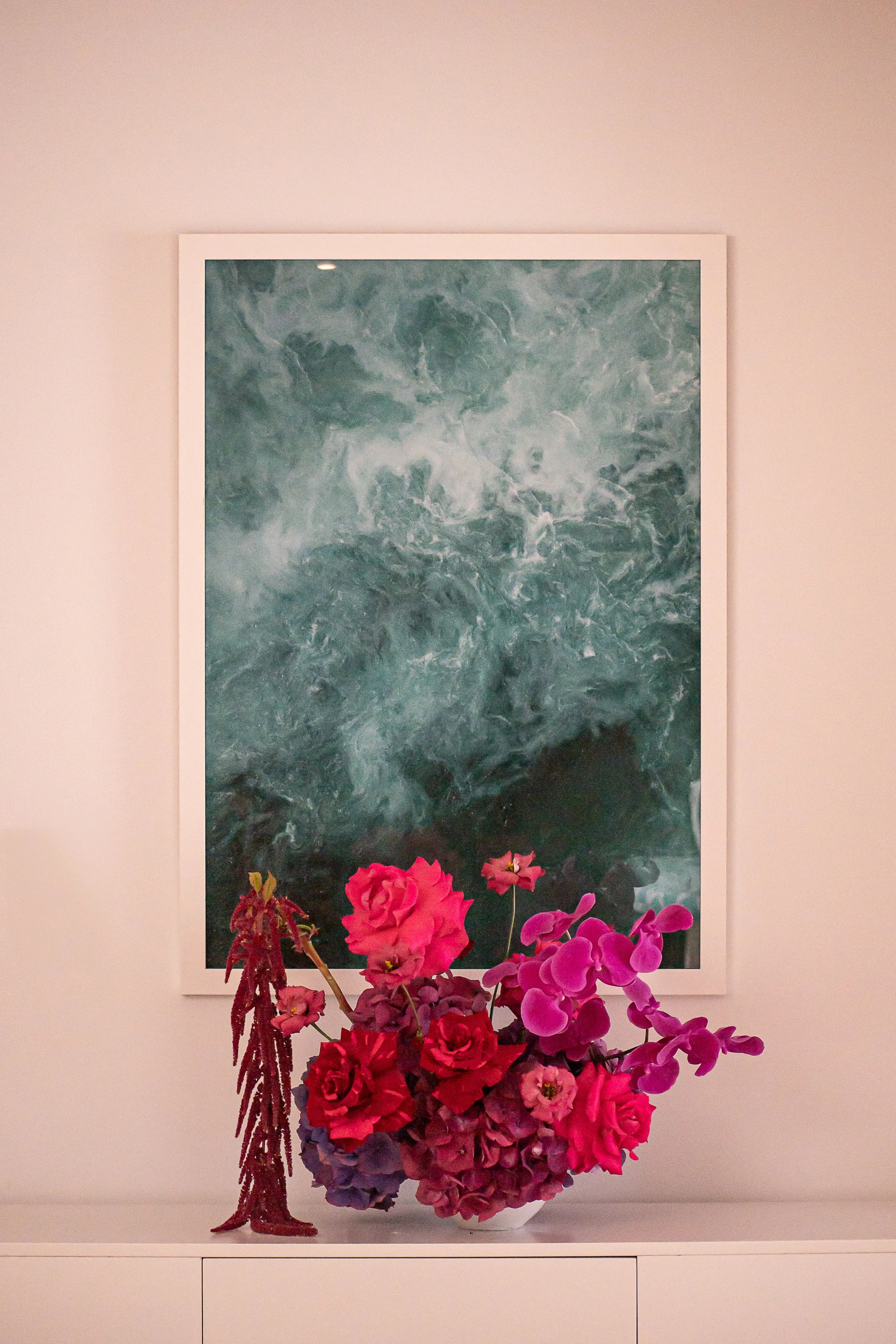Bold hallway table floral arrangement with roses hydrangea orchid lisianthus and amaranthus