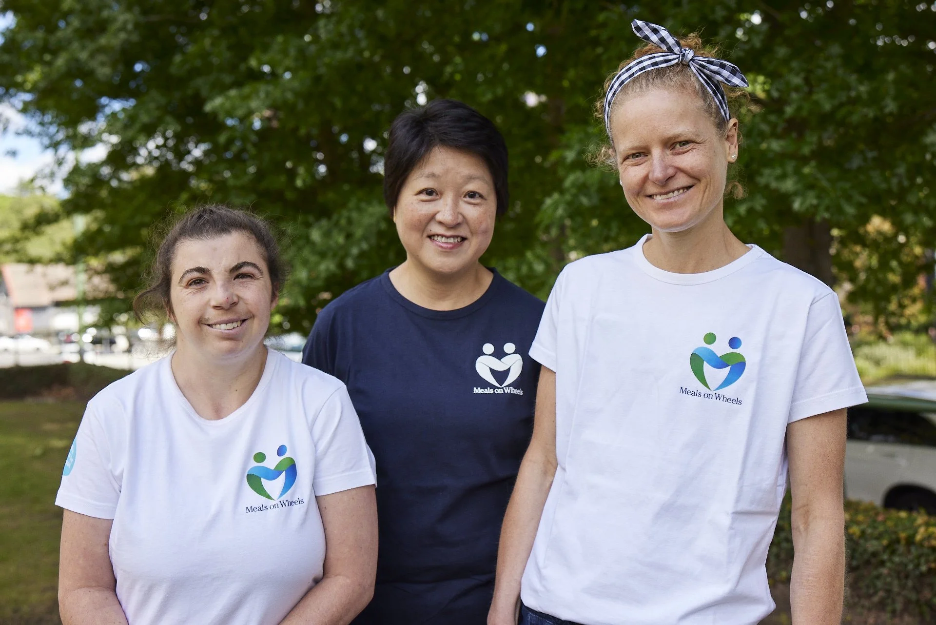 Two Blacktown Meals on Wheels volunteers smiling happily.
