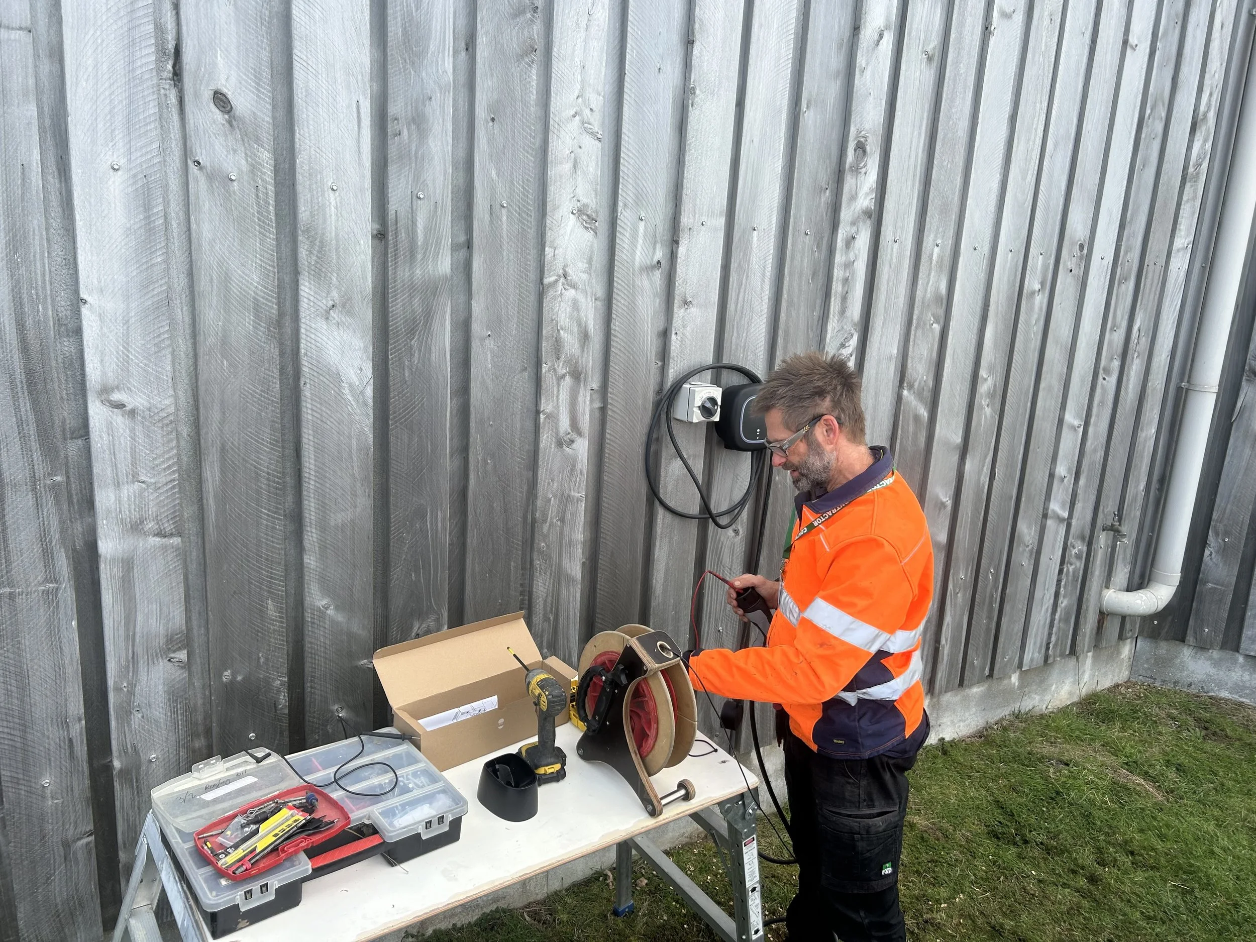 Our expert electrician Andrew installing an EV charger in Hobart