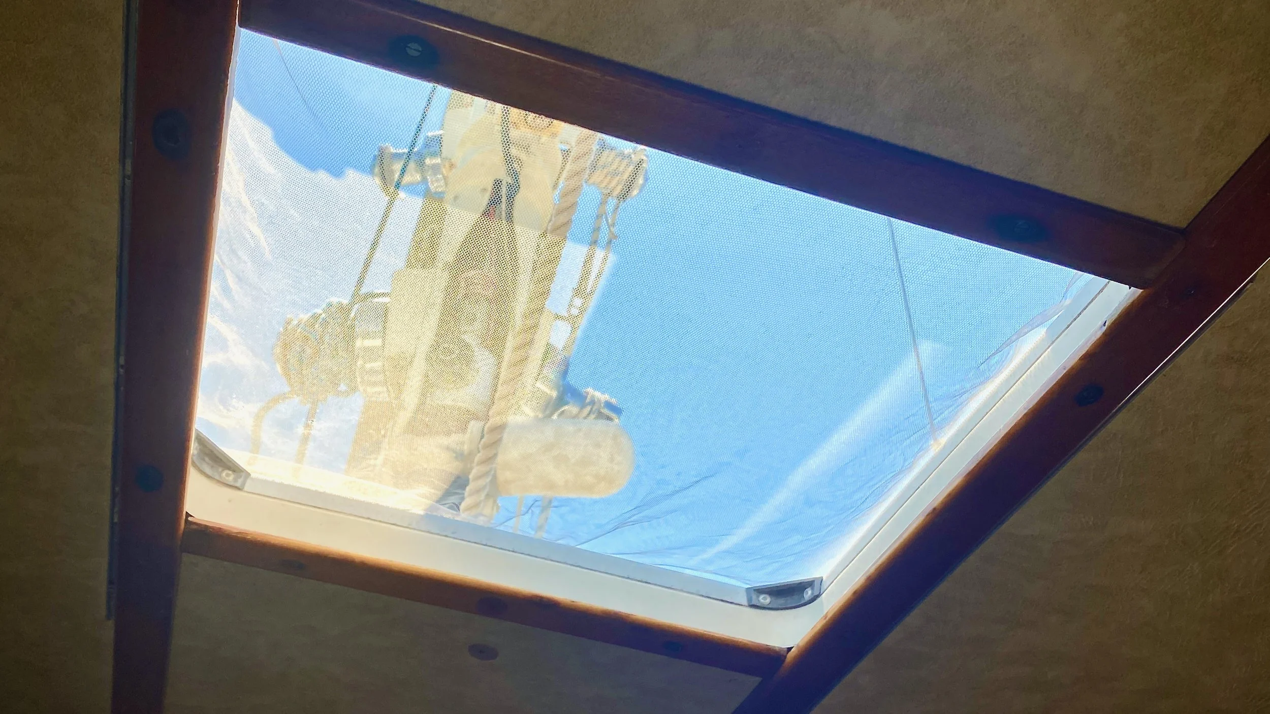A Sailboat hatch on S/V Mothership with a bug net over it