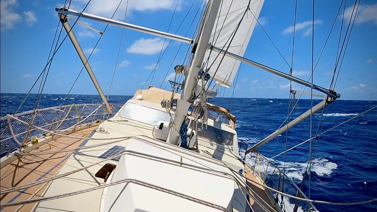 Sailboat - S/V Mothership - seen from foredeck healed over under sail