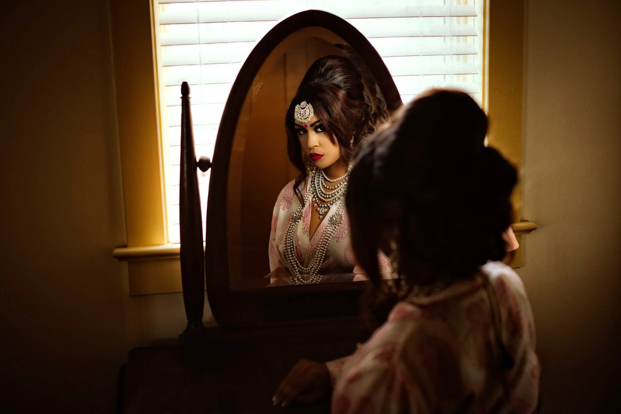 Maryland bridal boudoir portrait getting ready looking at reflection in mirror 