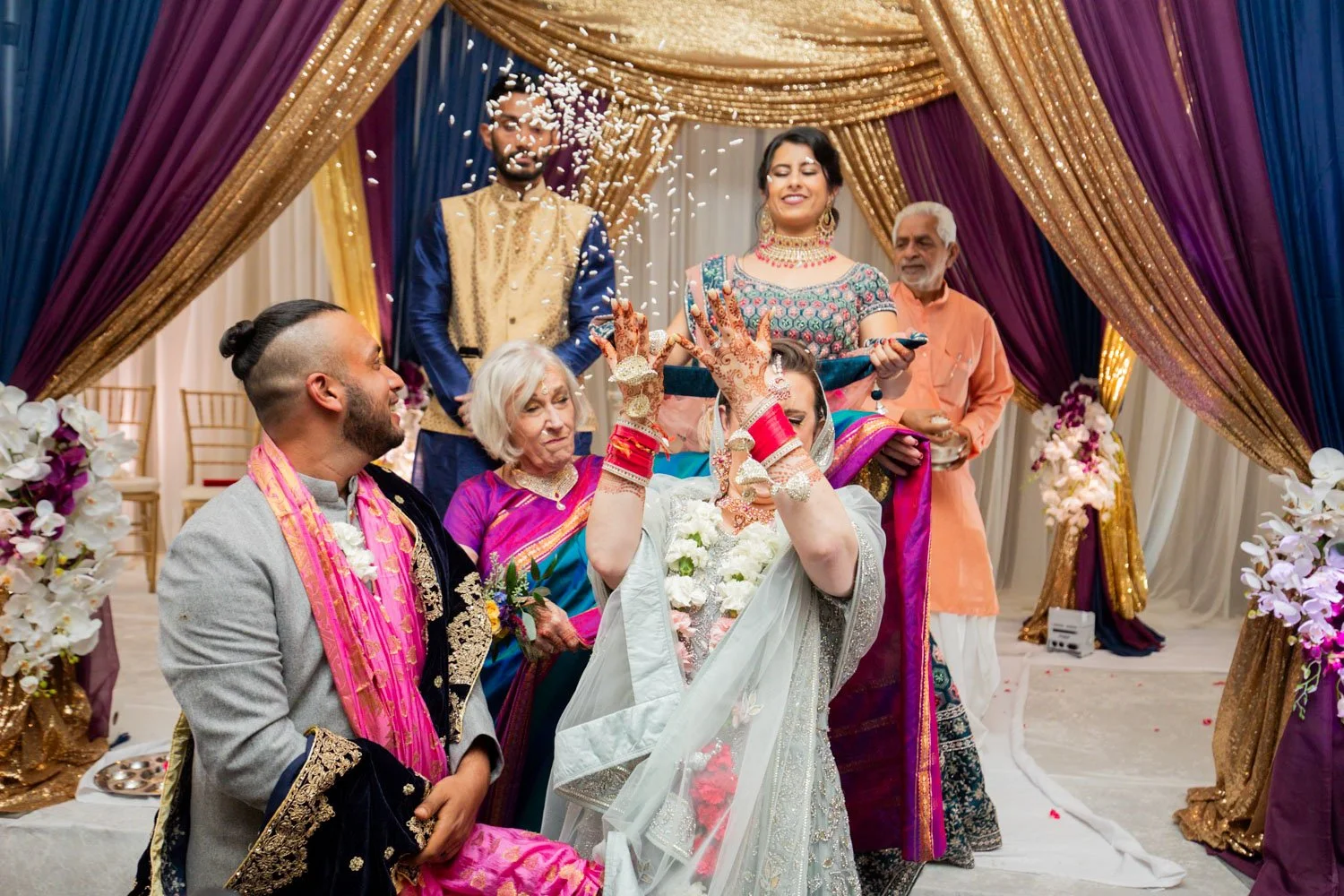 Bride throwing rice over her shoulder during recessional