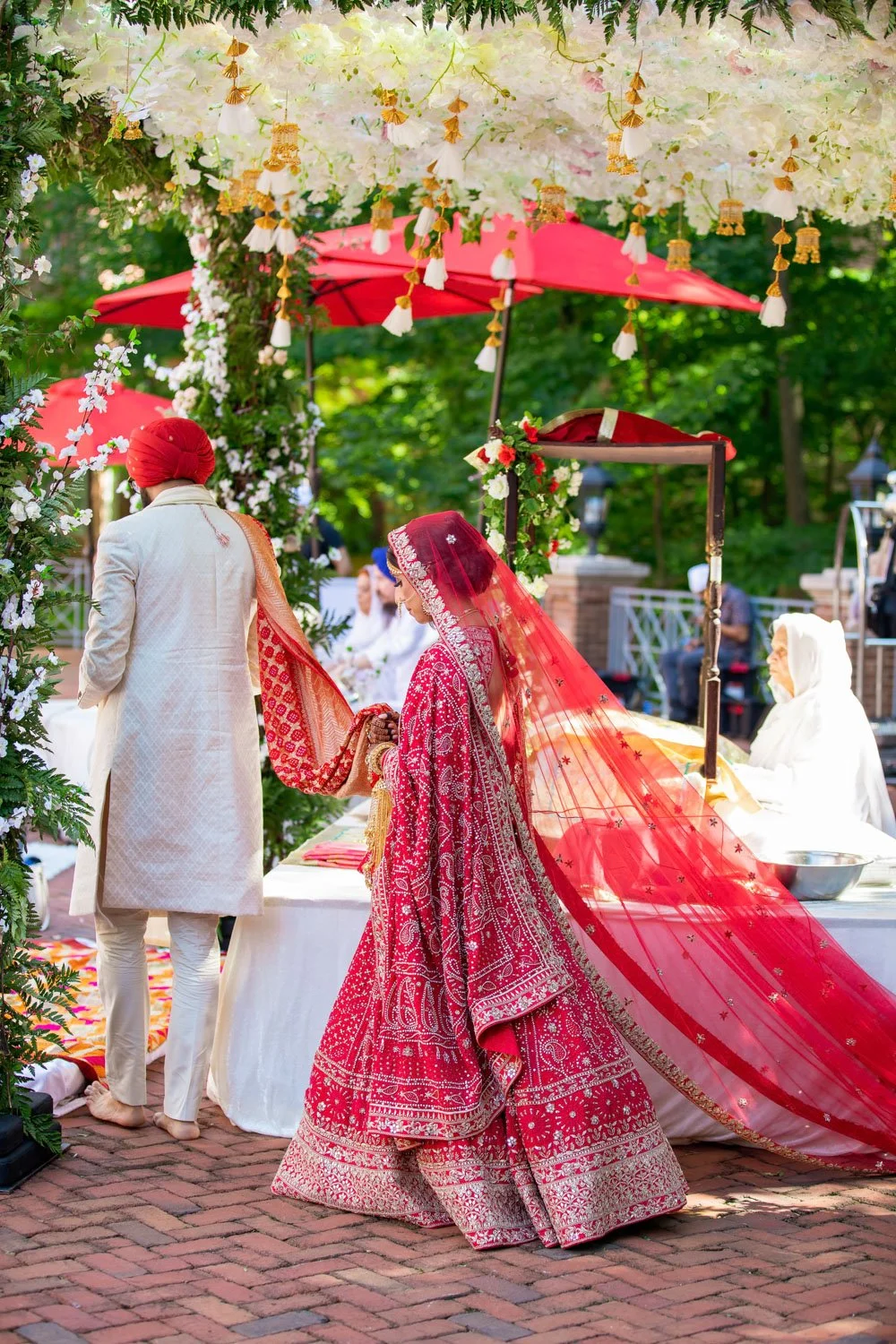 Lavan - Bride and groom walk around Guru Granth Sahib during Indian Sikh wedding ceremony at Westfields Marriott in Virginia