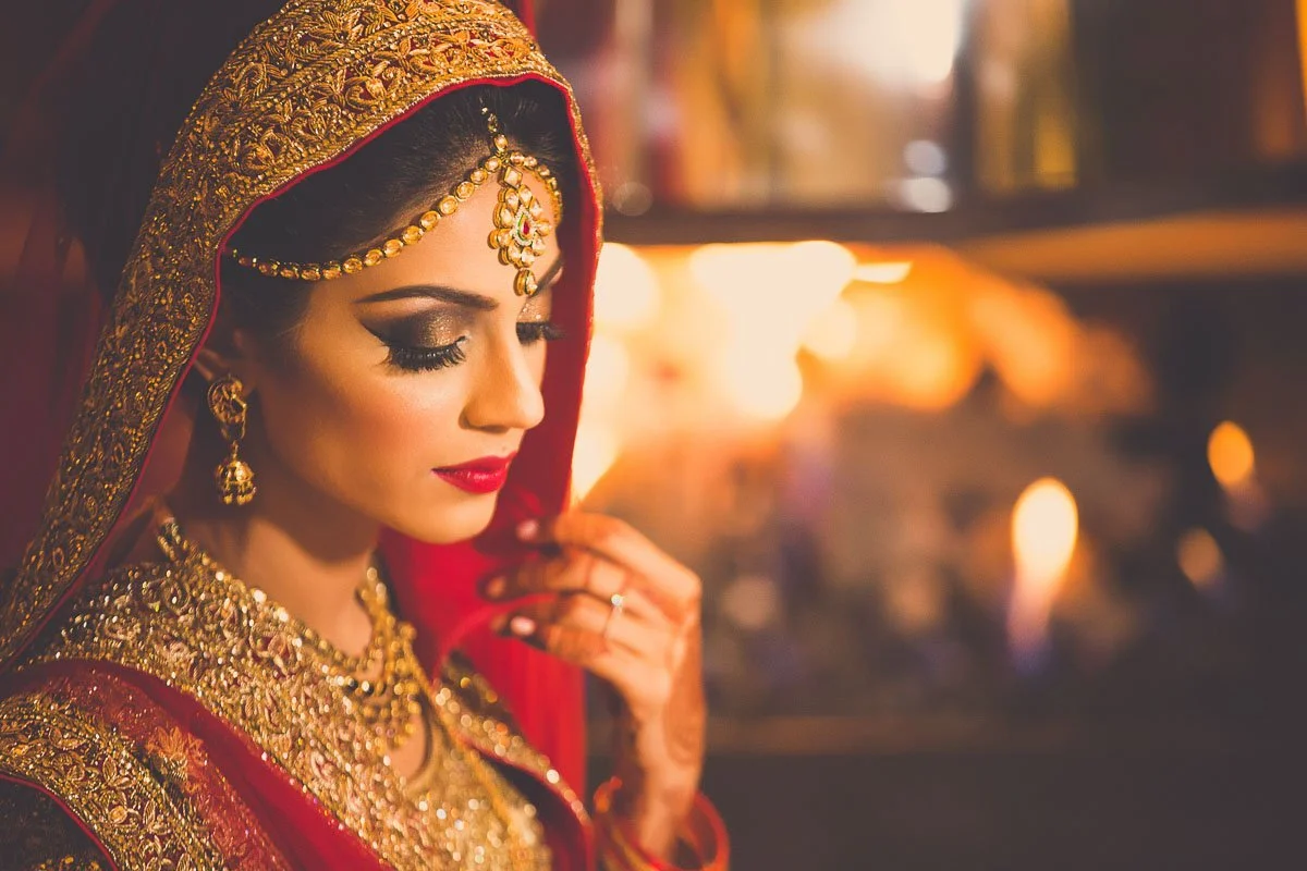 Indian bride in Manisha Malhotra in front of fireplace at Renaissance Schaumburg wedding rukhsati