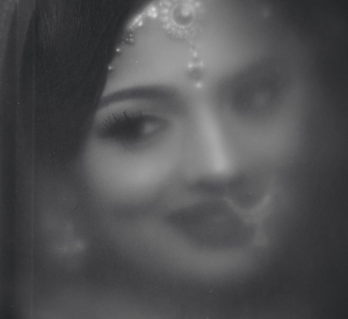 Vintage bridal portrait through window at Ritz-Carlton Tysons Corner Gujarati wedding