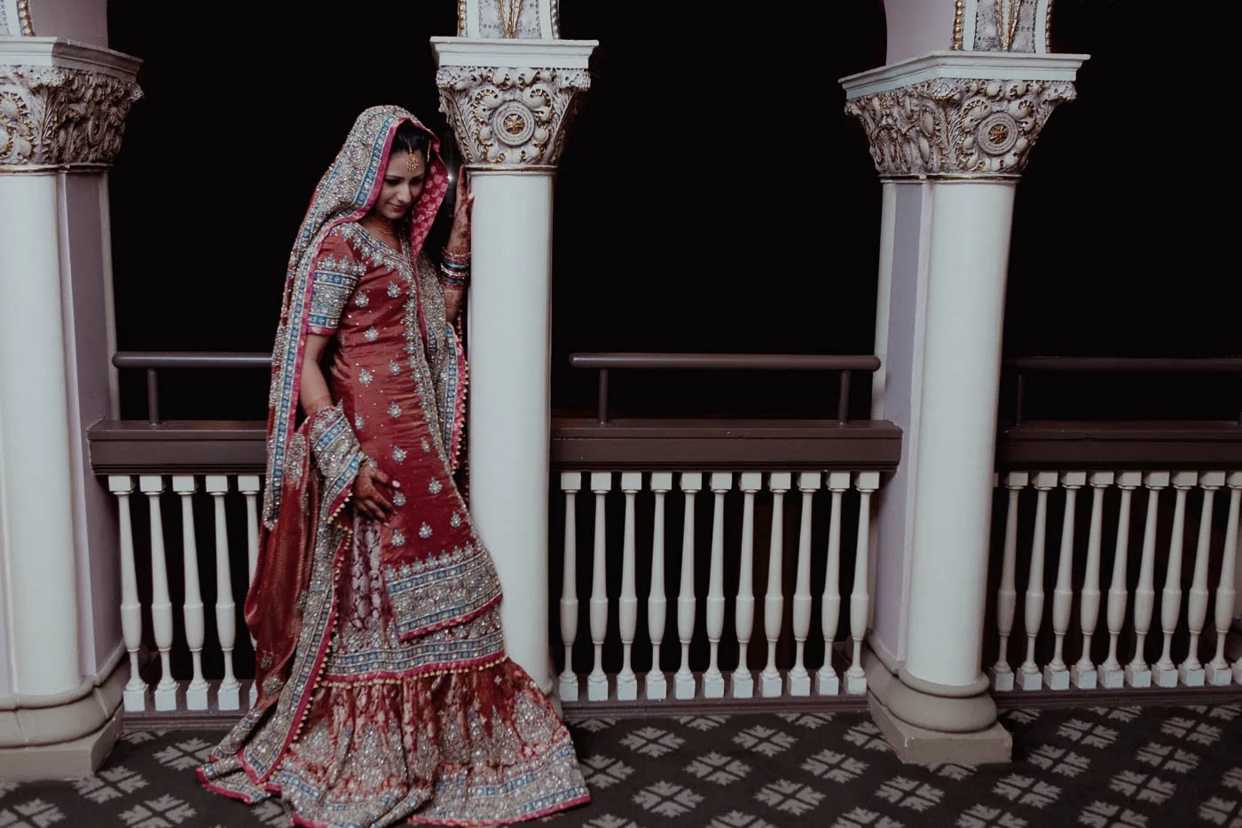 Bride posing against pillars before St Louis Union Station Pakistani wedding
